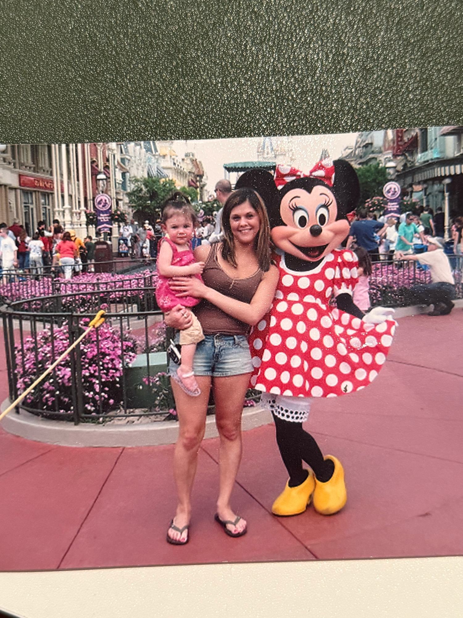 Emma Joyce Photo and her mom posing with Minnie Mouse in her iconic red polka dot dress at Disney World theme park in Orlando Florida