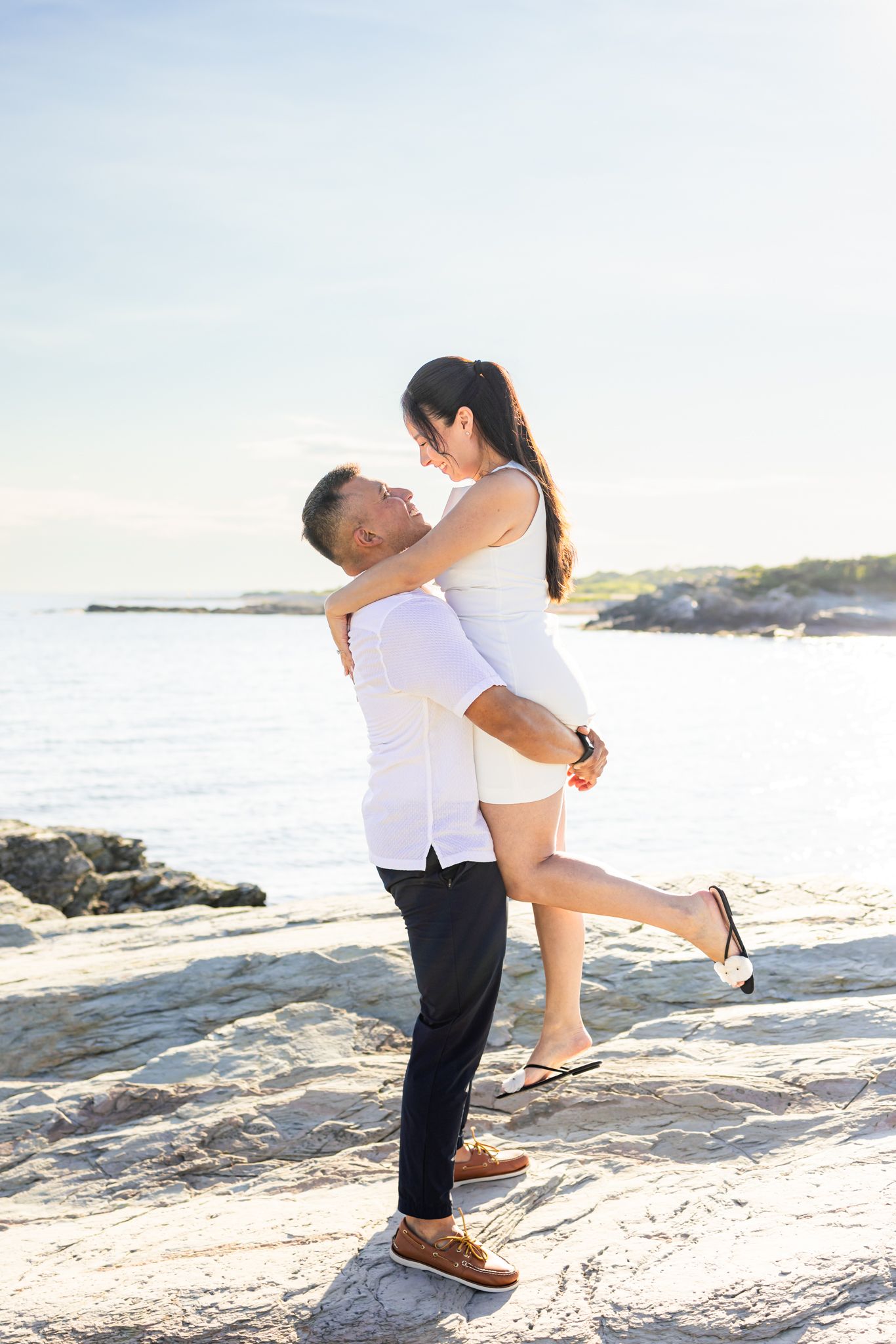 A romantic couple posing for engagement photo after surprise proposal in Newport Rhode Island