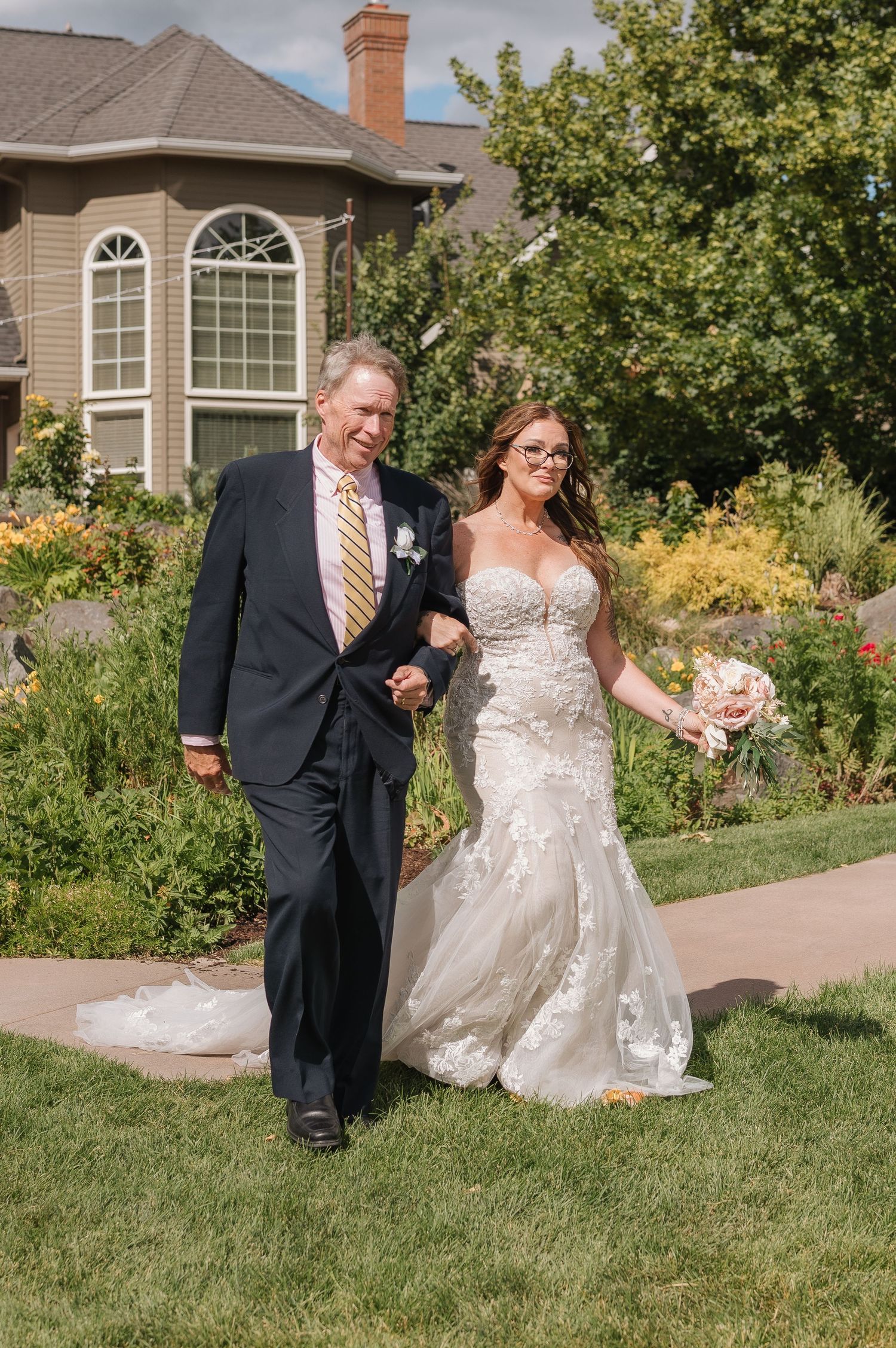 A wedding ceremony portrait moment outdoors at a lush garden countryside venue in Spokane, Washington. Wedding photography.