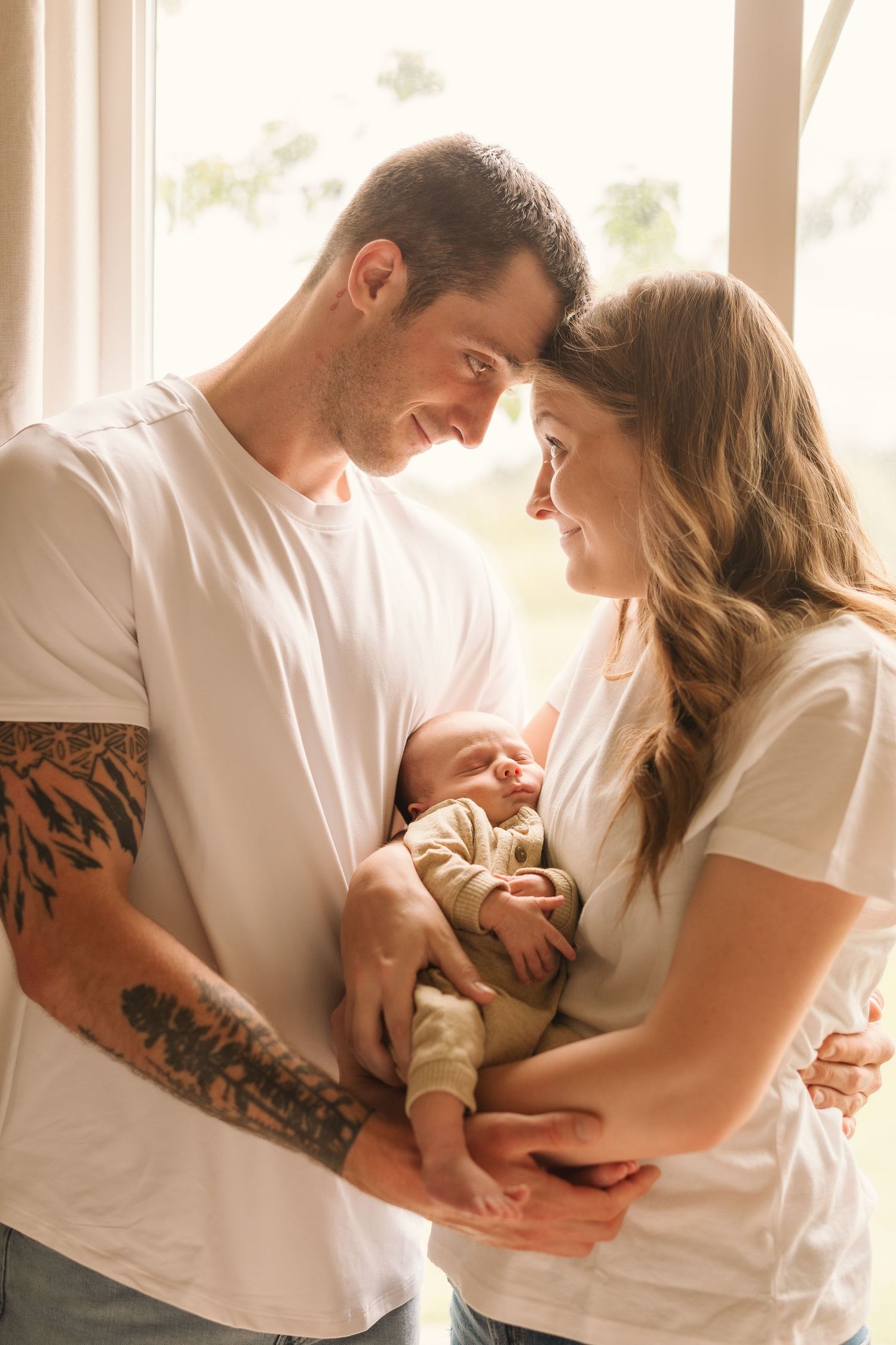 Intimate lifestyle photos of a couple in white shirts sharing tender moments together.