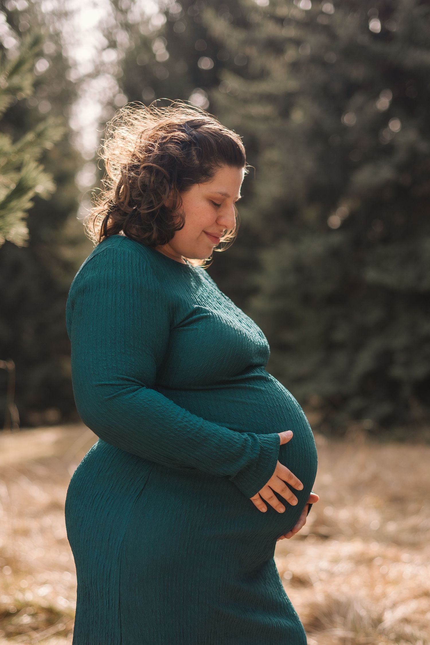 A progression of photos shows a person in a teal sweater cradling their pregnant belly in soft natural lighting.
