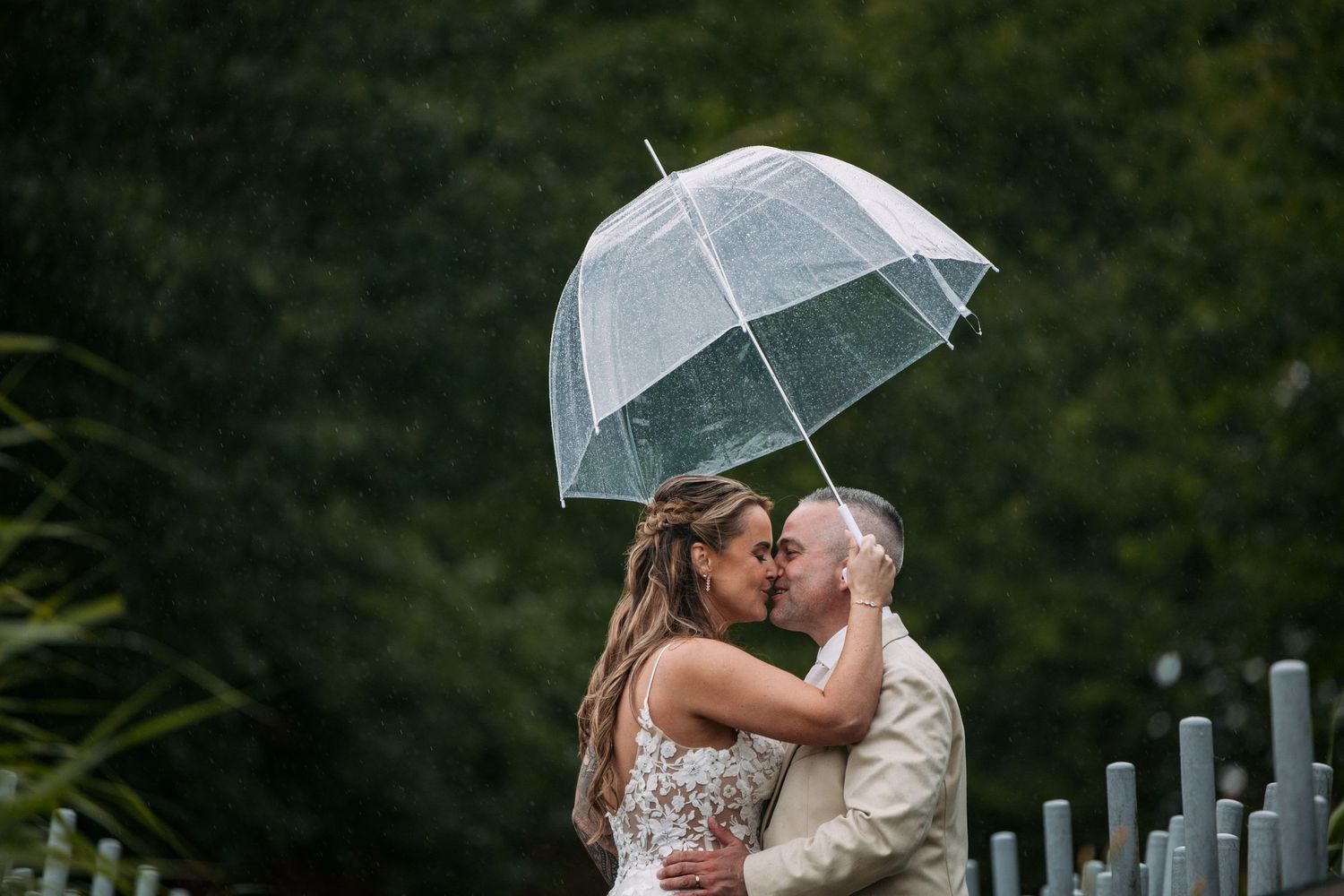 bruidspaar in de regen met een paraplu verliefd