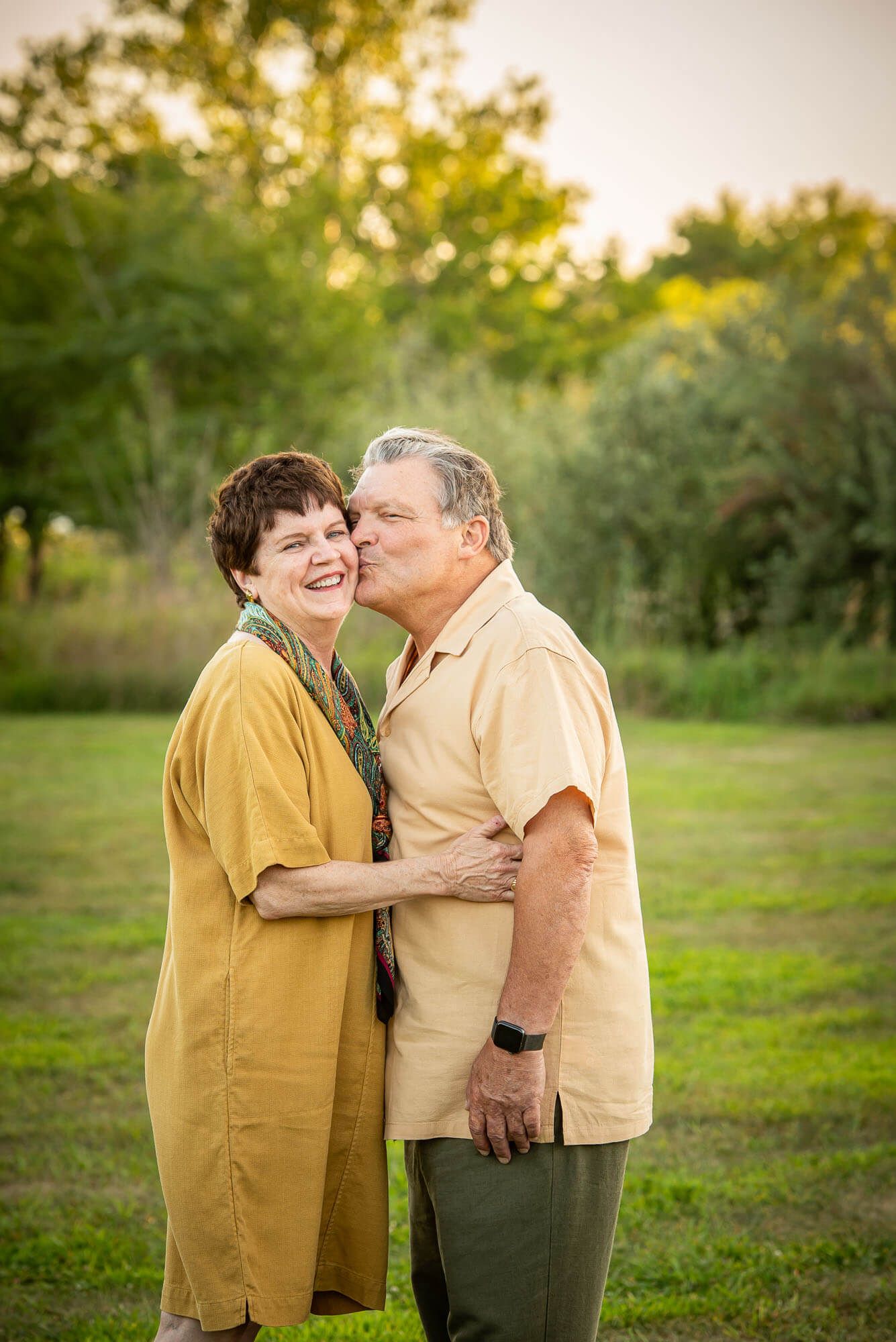Loving couple sharing intimate moments in a natural setting during golden hour during an Omaha couple's photography session at Lake Chalco.