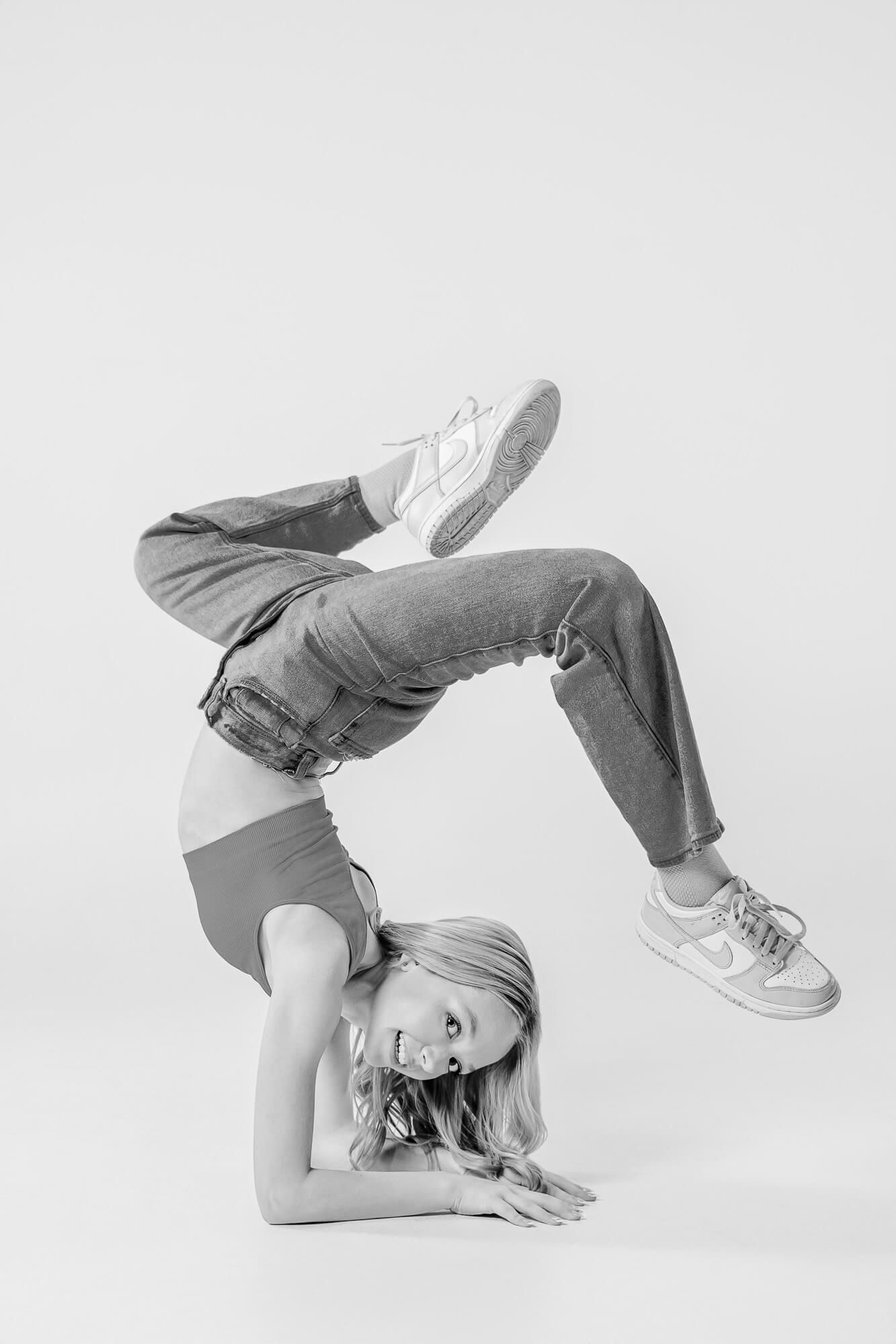A black and white photo sequence showing a dynamic breakdancing move with someone flipping and spinning on the ground.