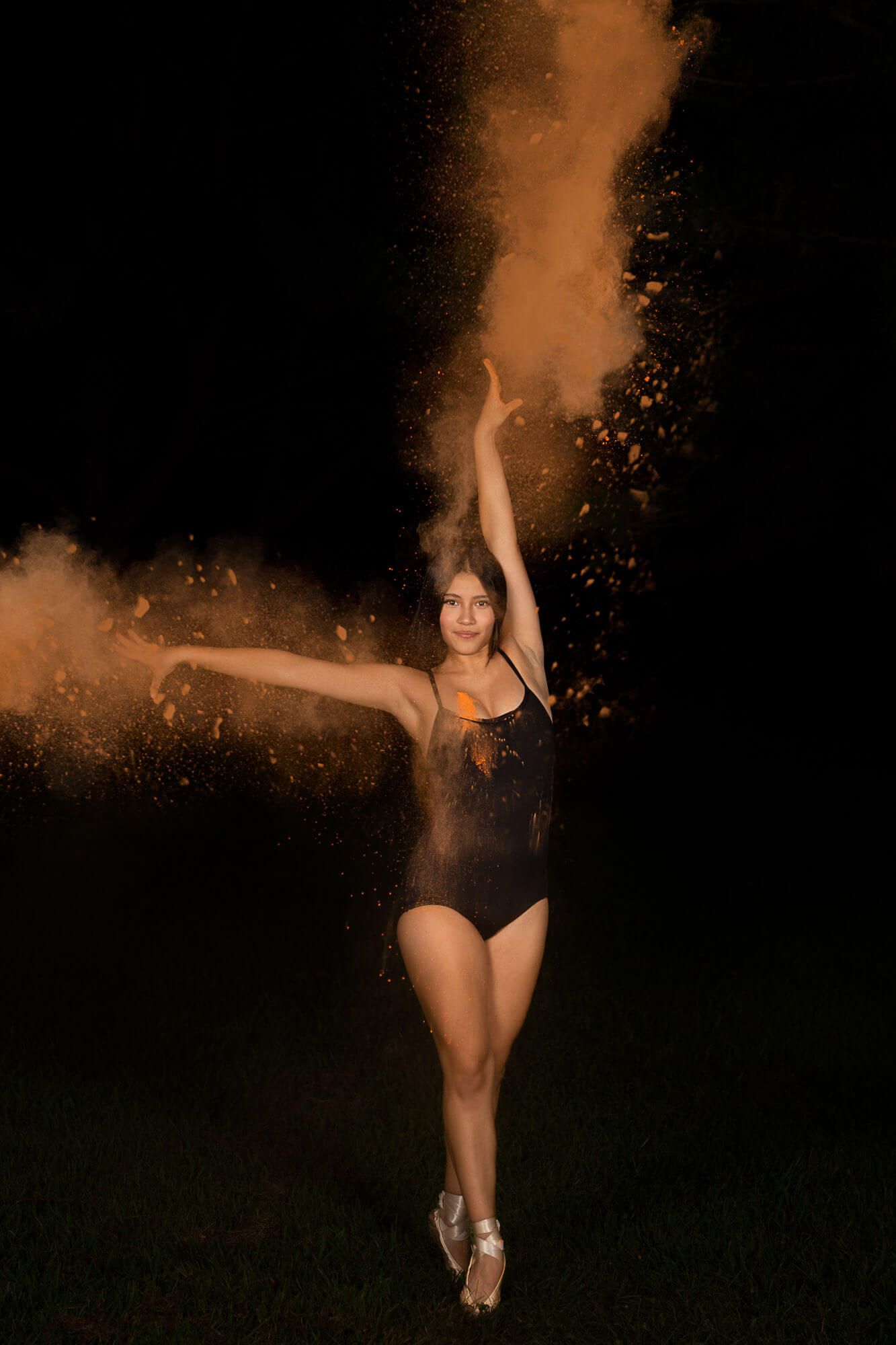 Dramatic dance photos with colored powder effects creating ethereal movement against a black background.