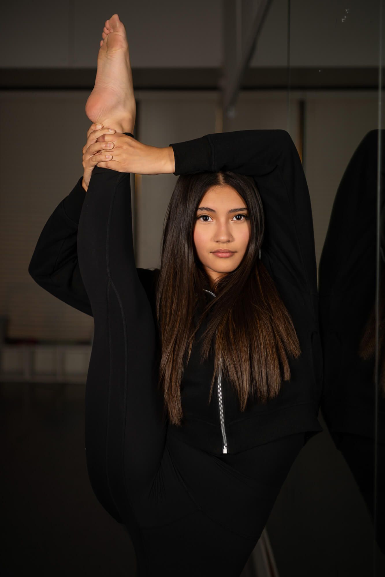 A series of moody portraits showing a person in a black hoodie making different poses against a dark background.