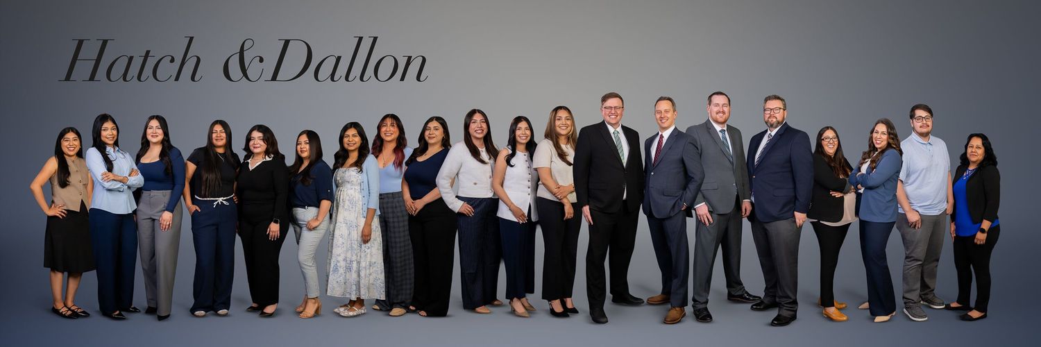 Professional team photo of Hatch & Dallon law firm  in Omaha staff in business attire posed together against a gray background.
