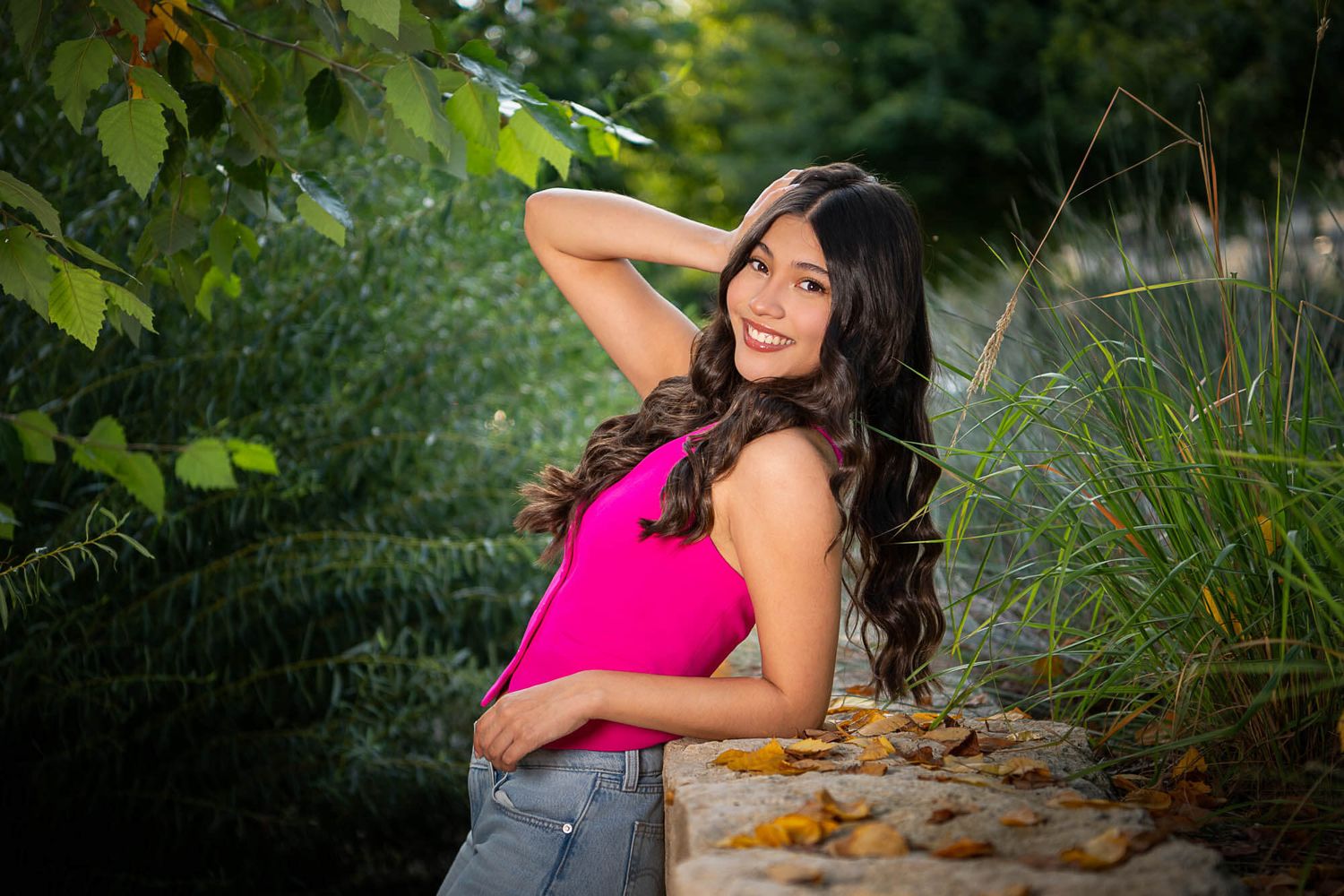 Outdoor portrait session in garden setting with natural lighting and greenery.