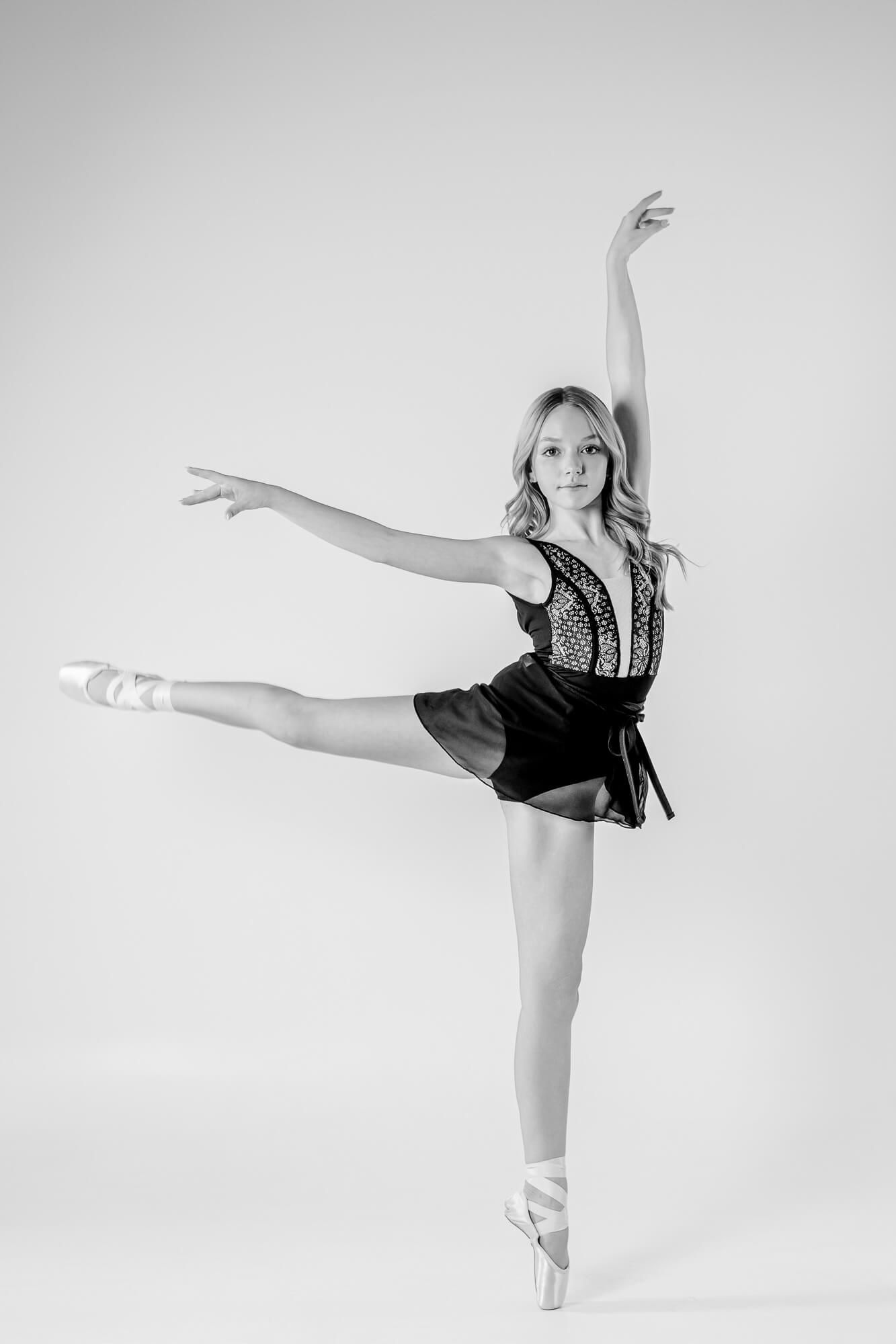 A series of graceful ballet poses captured in black and white showing extended leg movements against a white backdrop.