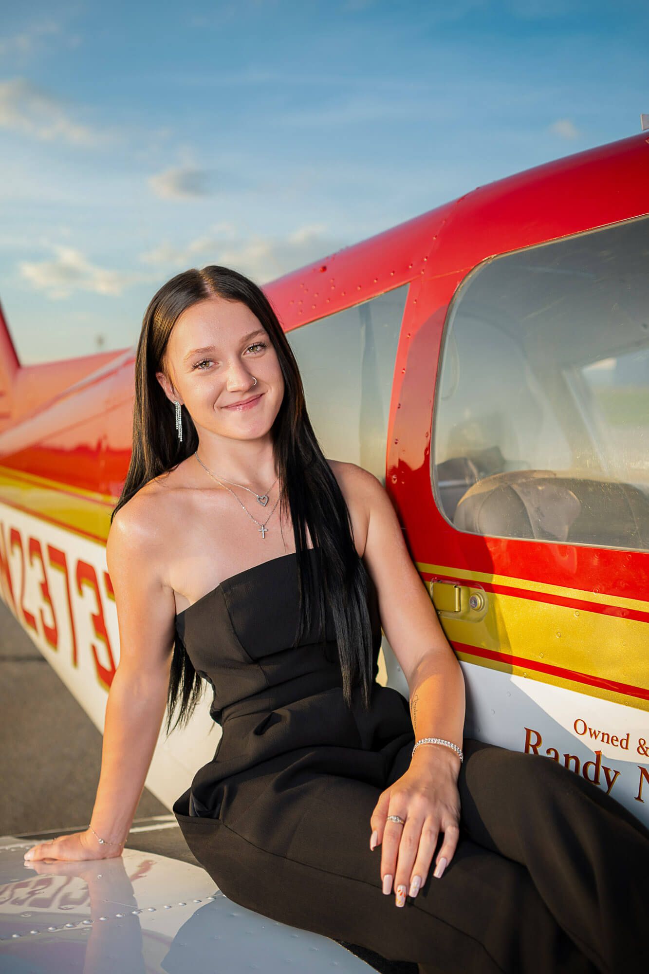 A collection of portrait photos taken at sunset featuring someone in a black dress posing near a small aircraft.