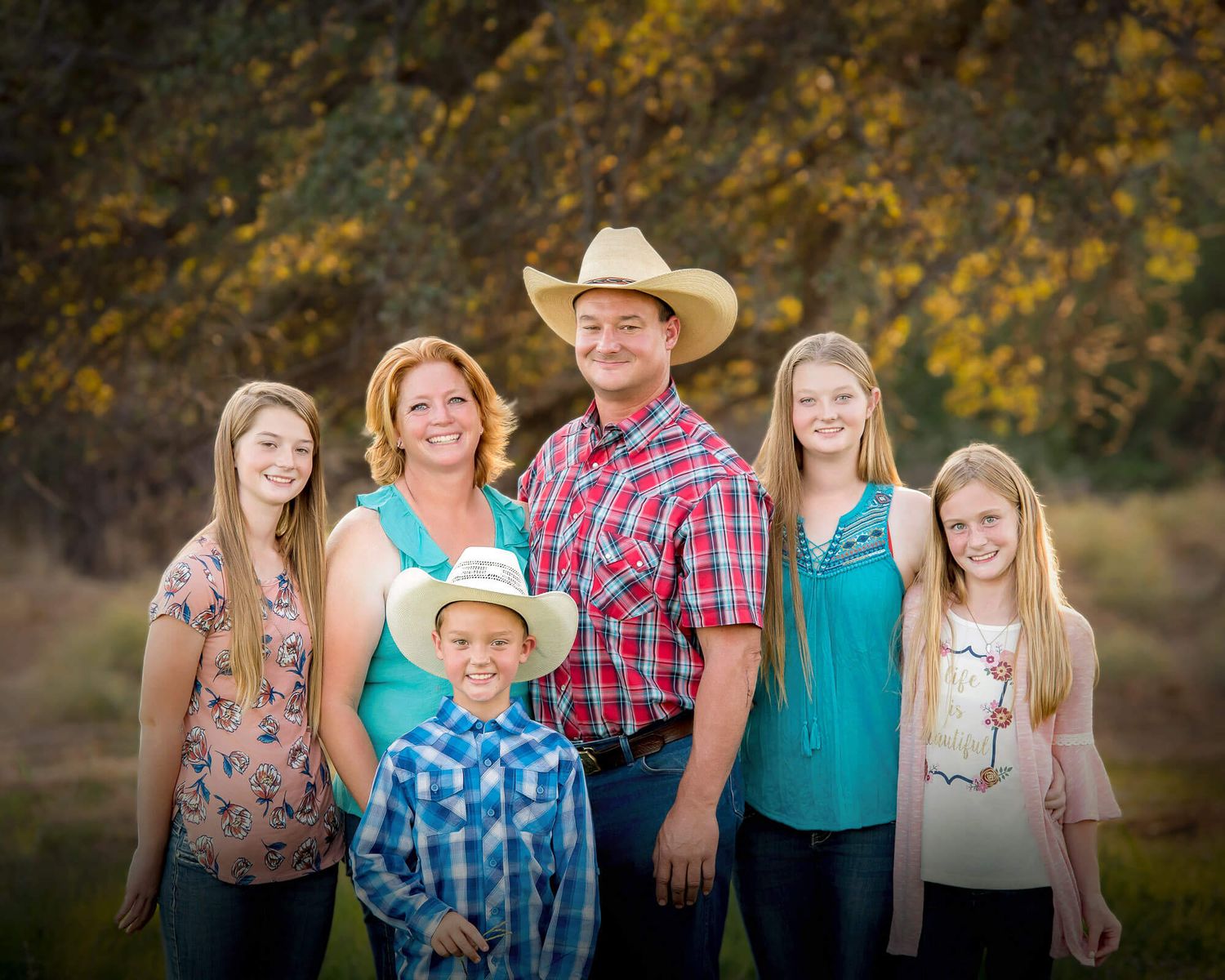 A series of outdoor family portraits with warm autumn colors and golden foliage in the background.
