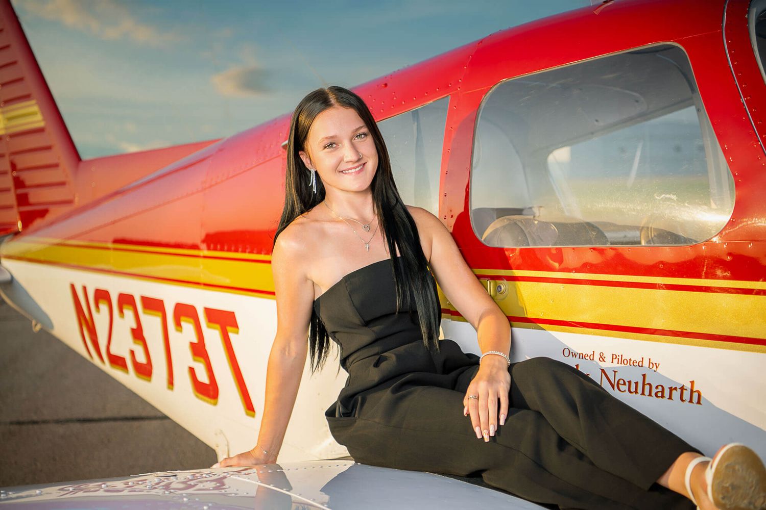 A series of sunset photos showing a red and white aircraft parked on an airfield with golden sky in the background.