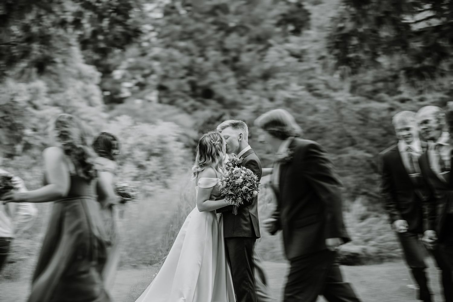 Black and white candid photo capturing wedding ceremony moments.
