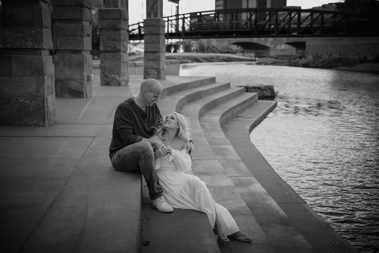 A series of black and white photographs showing people sitting by a waterfront in an urban setting.