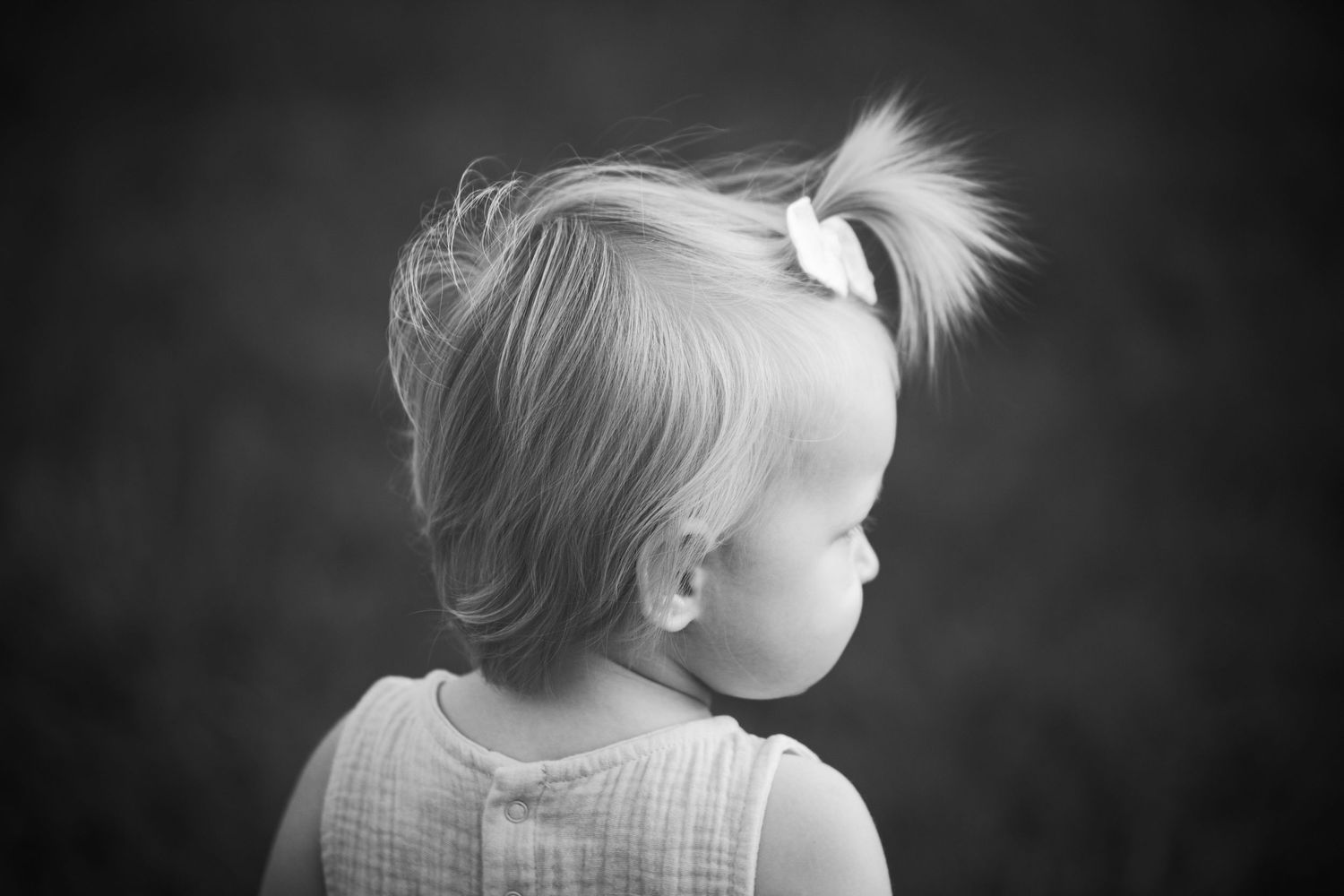 A series of black and white profile shots showing different hairstyles and lighting effects against dark backgrounds.