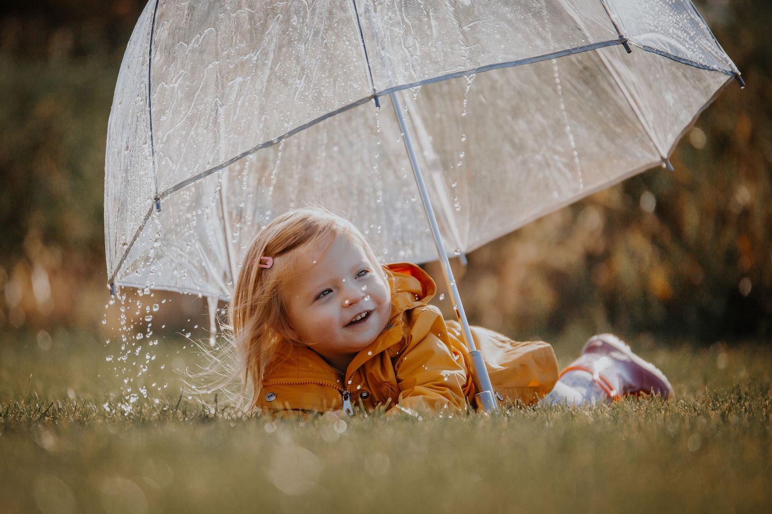 White umbrella laying on grass with soft natural lighting. Photographer in Sioux Falls, SD
