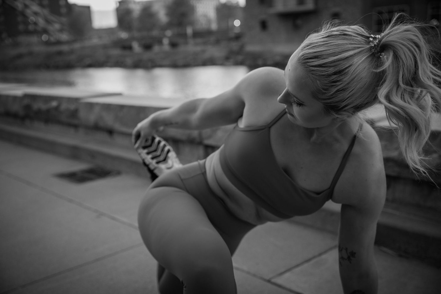 Athletic figure performs strength training exercises in urban setting during workout session.