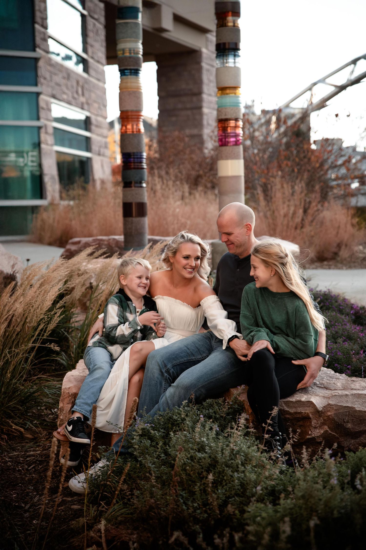 Family enjoying candid moments together on urban architecture with ornate pillars.
