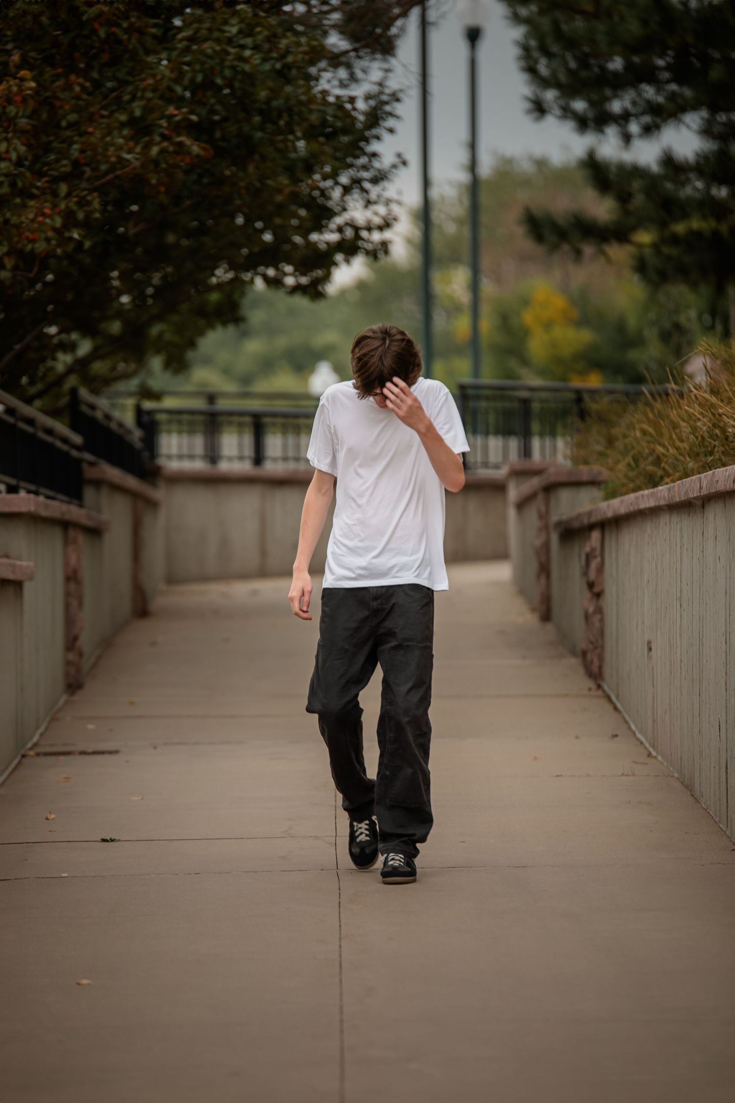 Long concrete walkway with someone walking away in casual clothing. Photographer in Sioux Falls, SD