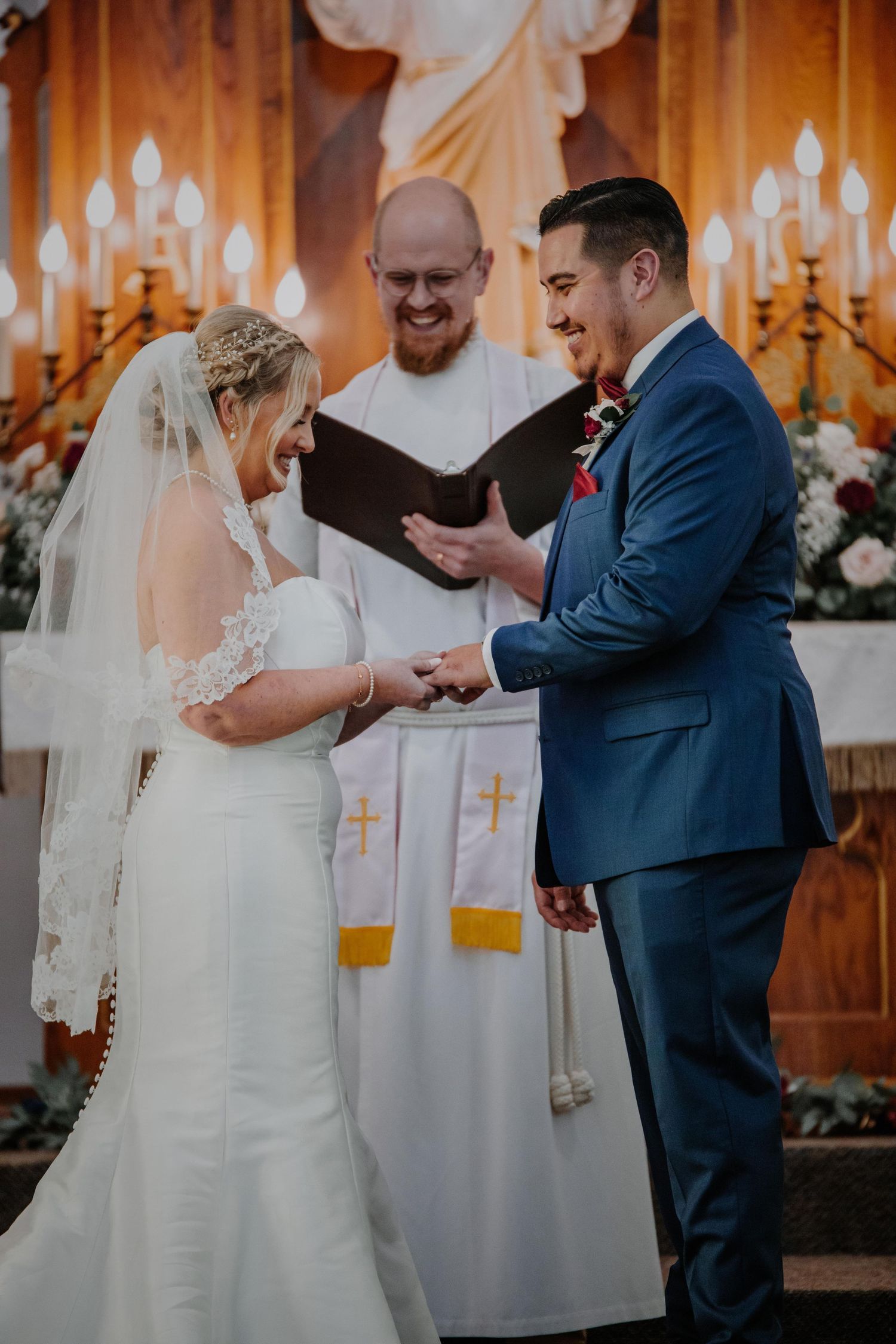 Wedding ceremony moments inside a warmly lit wooden venue with romantic lighting.