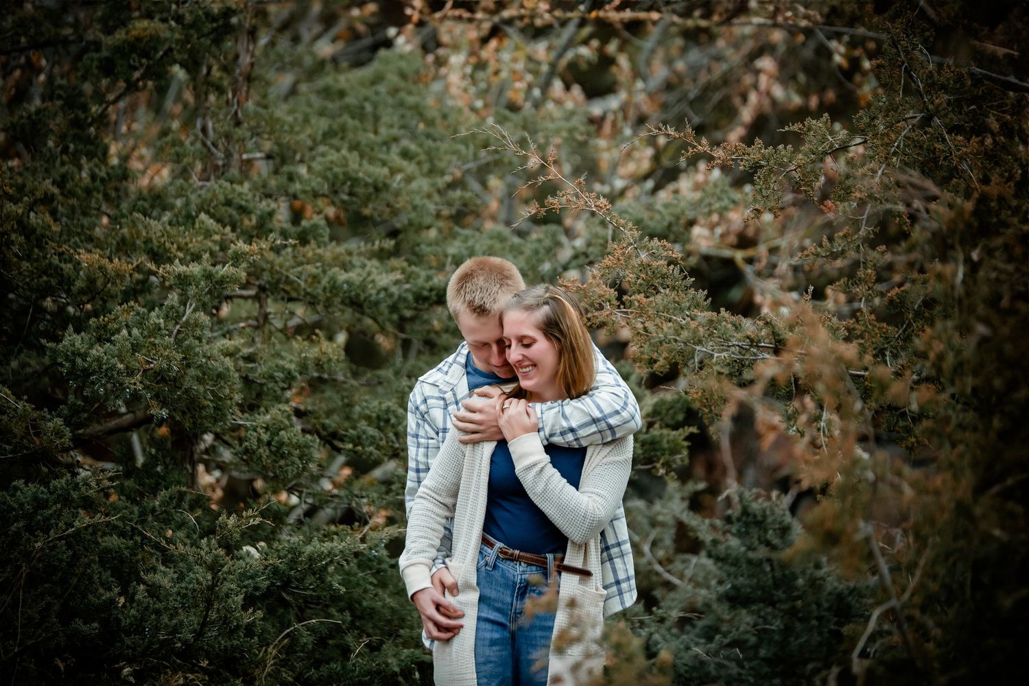 Casual engagement portraits in autumn outdoor setting with natural lighting. Photographer in Sioux Falls, SD