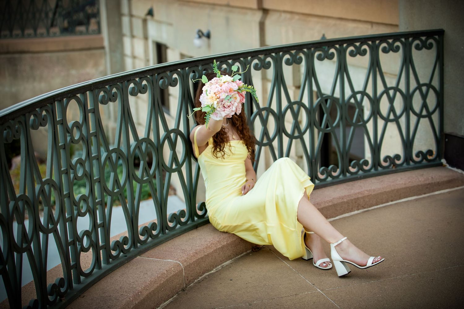 A series of romantic wedding photos showing a couple in yellow dress and formal wear posing along an ornate railing.