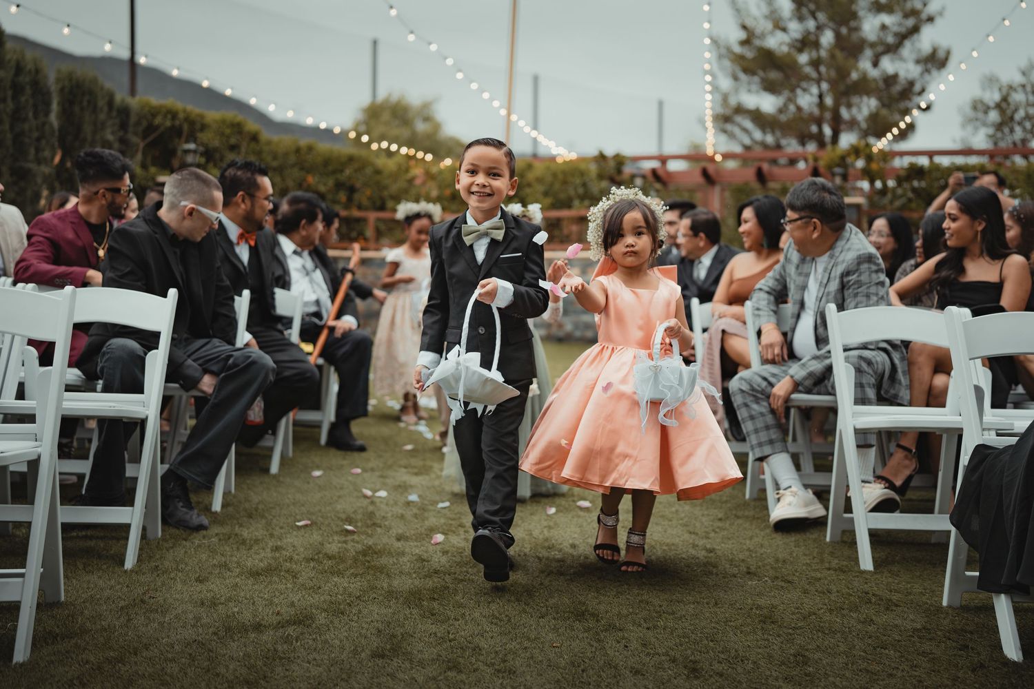 Flower girl and Ring bearer walk down aisle before the  wedding begins.