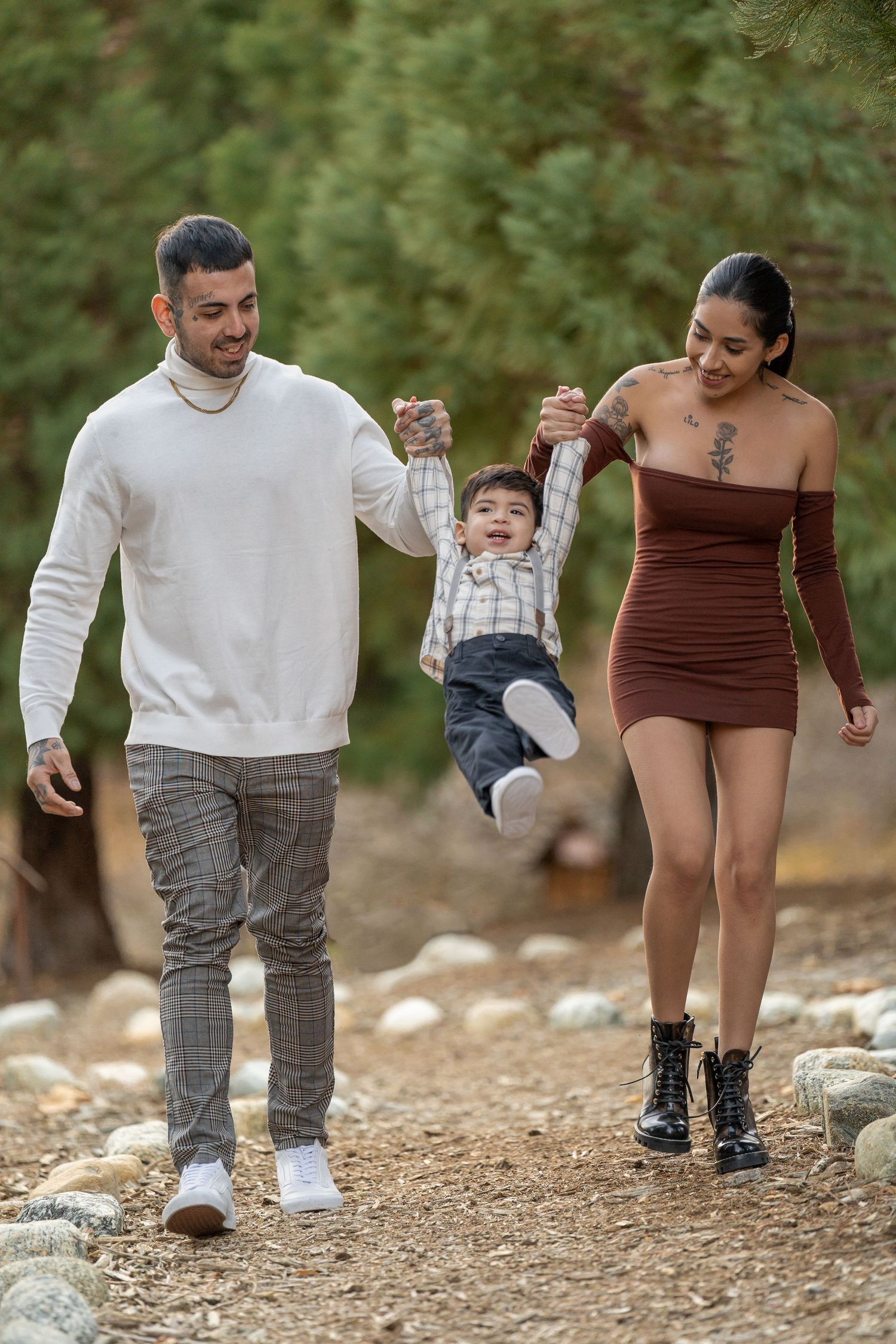 Family walking together on a rocky path during an outdoor photo session.