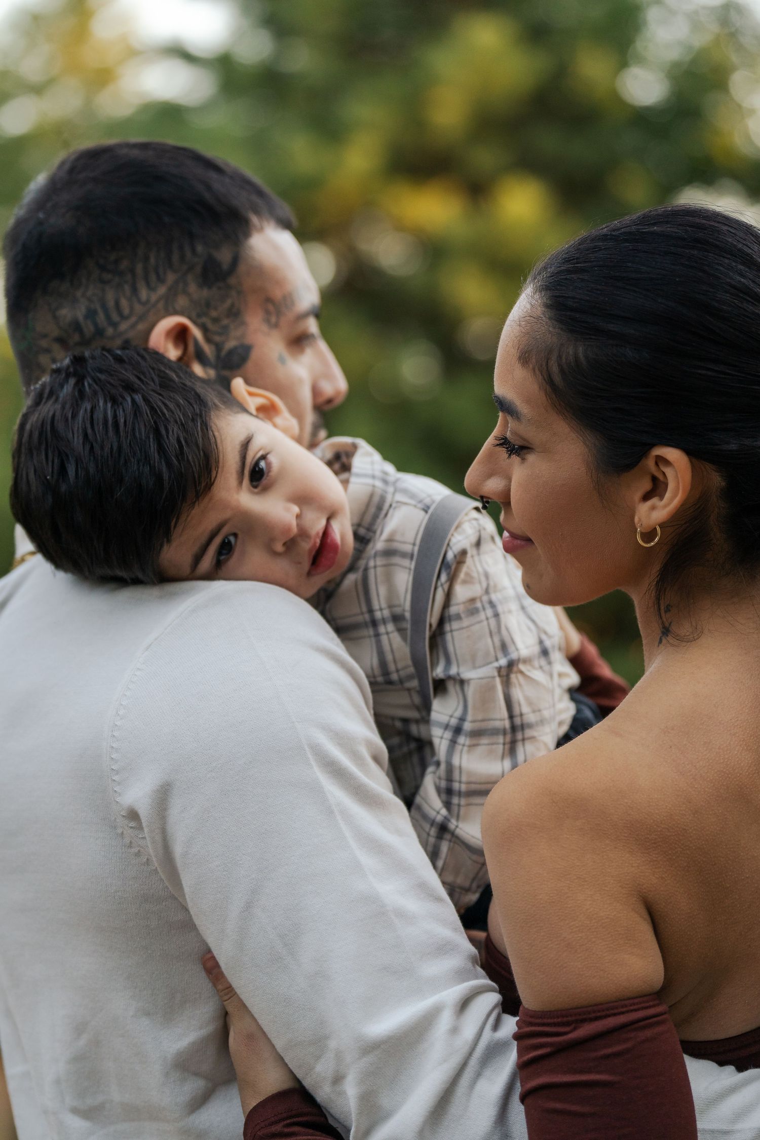 Intimate family portrait captured in warm outdoor lighting during sunset.