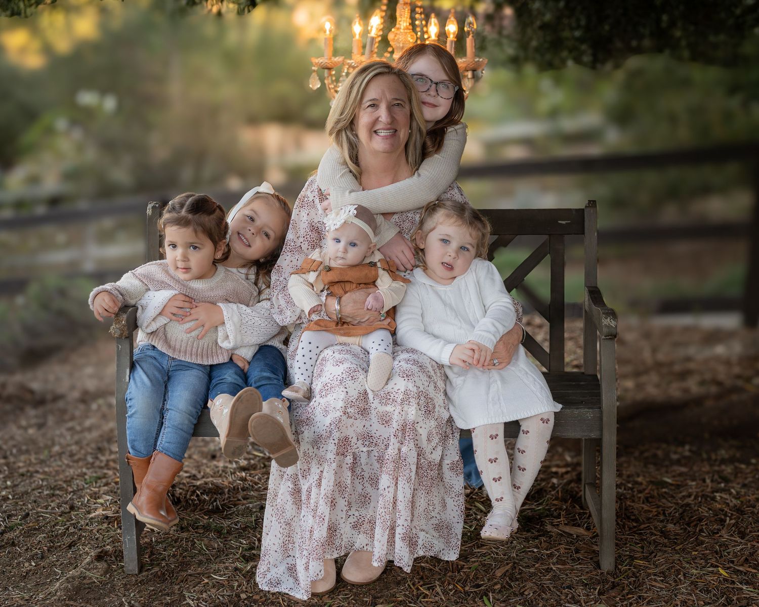 Family members sharing tender moments while sitting on a rustic bench outdoors.