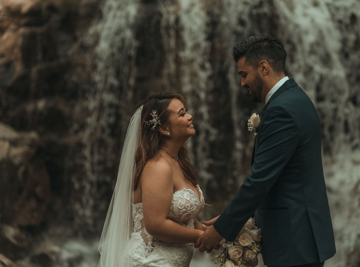 Romantic wedding ceremony moments captured against a textured stone backdrop.