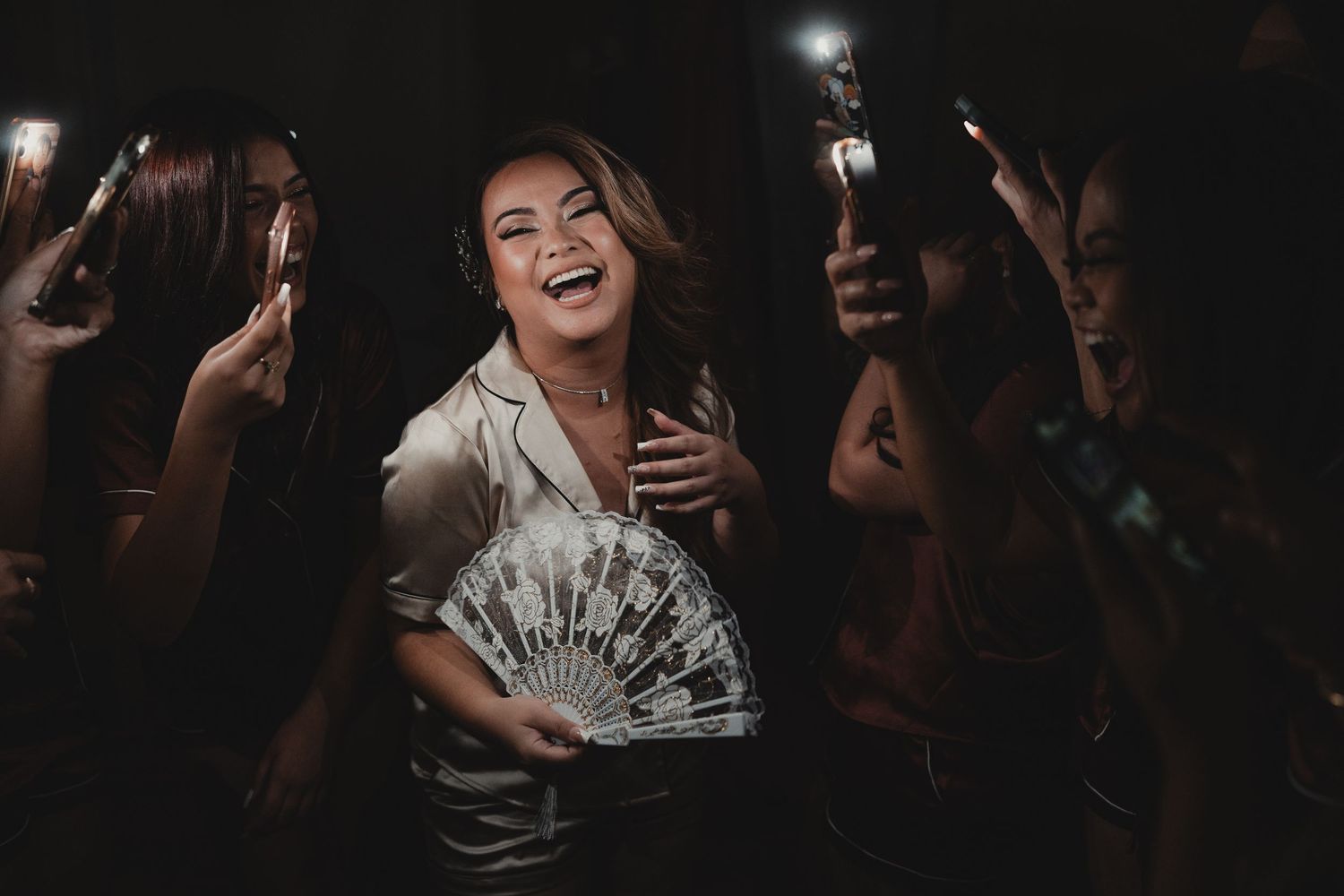 Wedding celebration at night with guests holding sparklers creating a magical atmosphere.