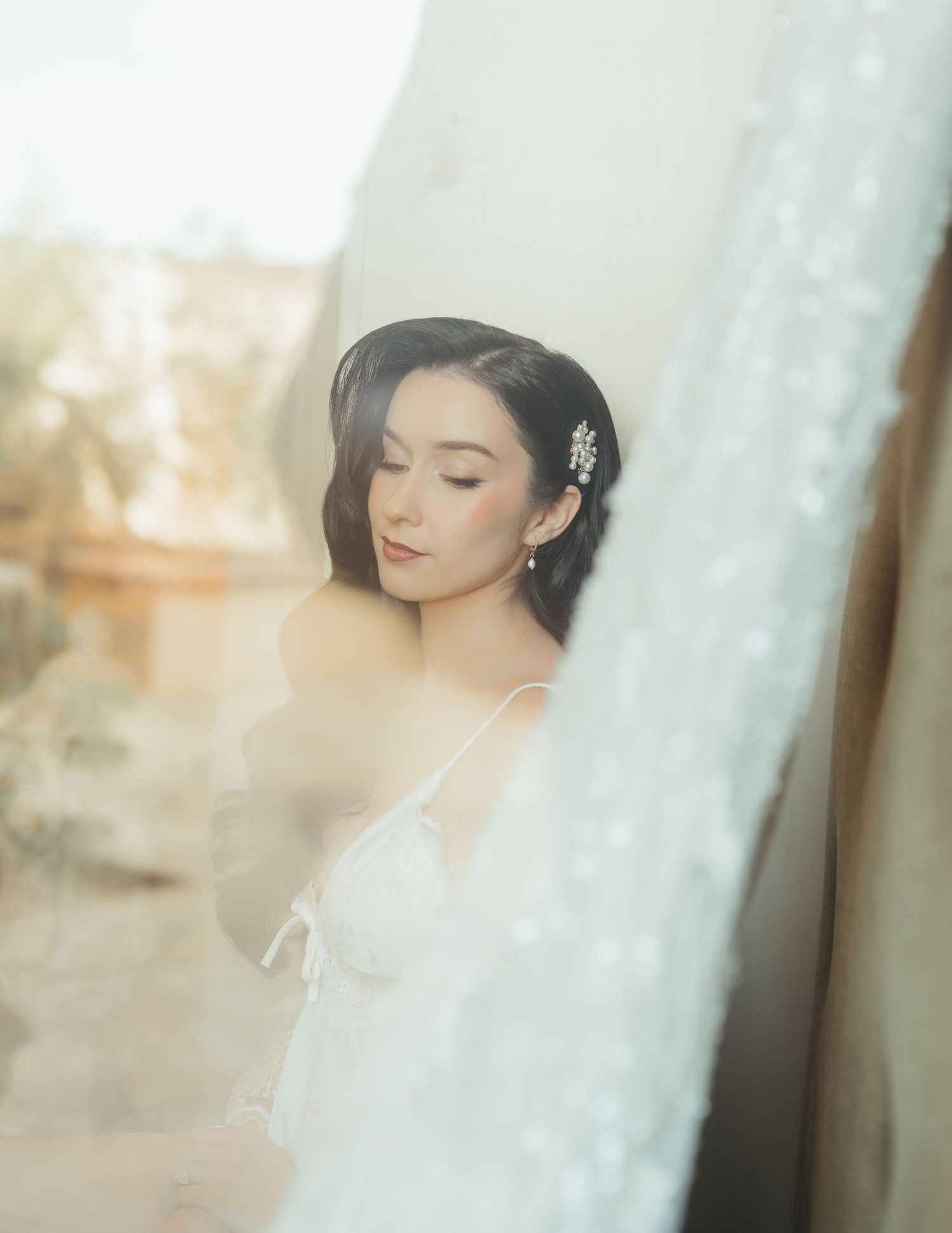 A soft, ethereal portrait series in muted tones shows a figure in romantic bridal styling against a light backdrop.