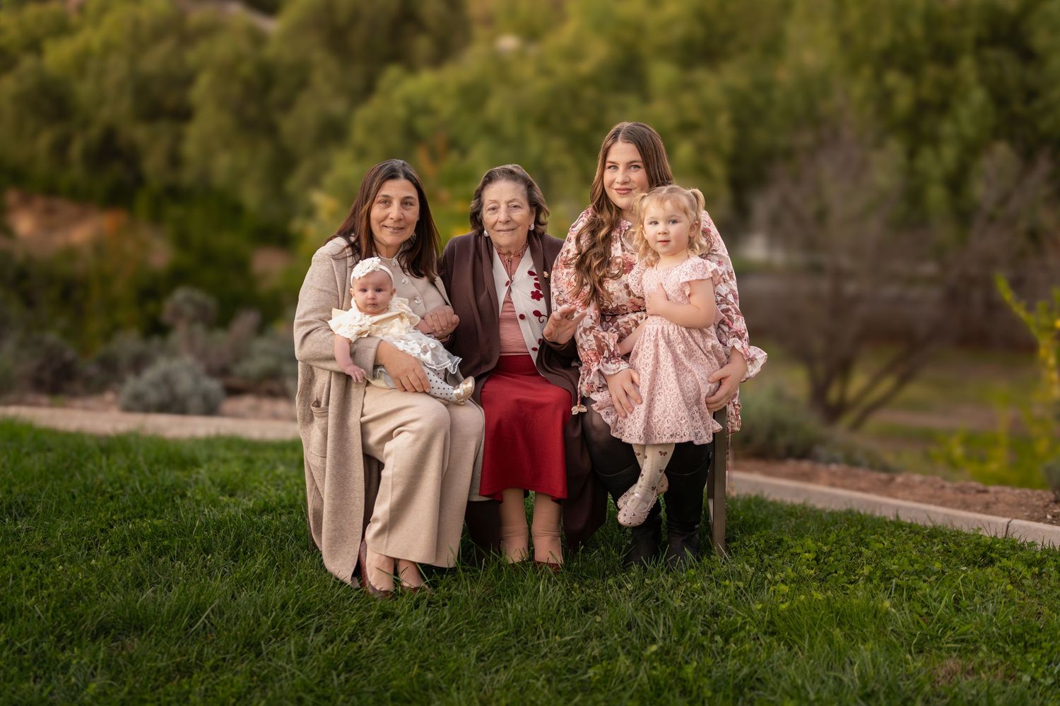 Multi-generational family members posing for casual outdoor portraits in natural setting.