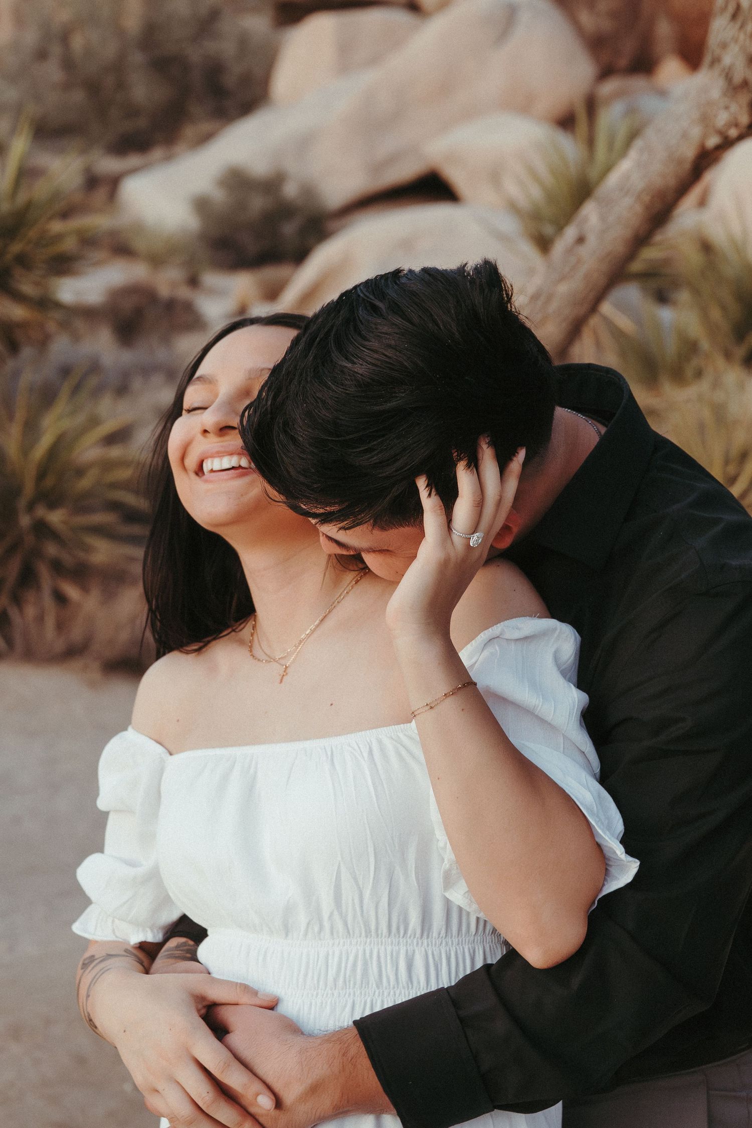 An intimate embrace captured during a desert proposal photoshoot.