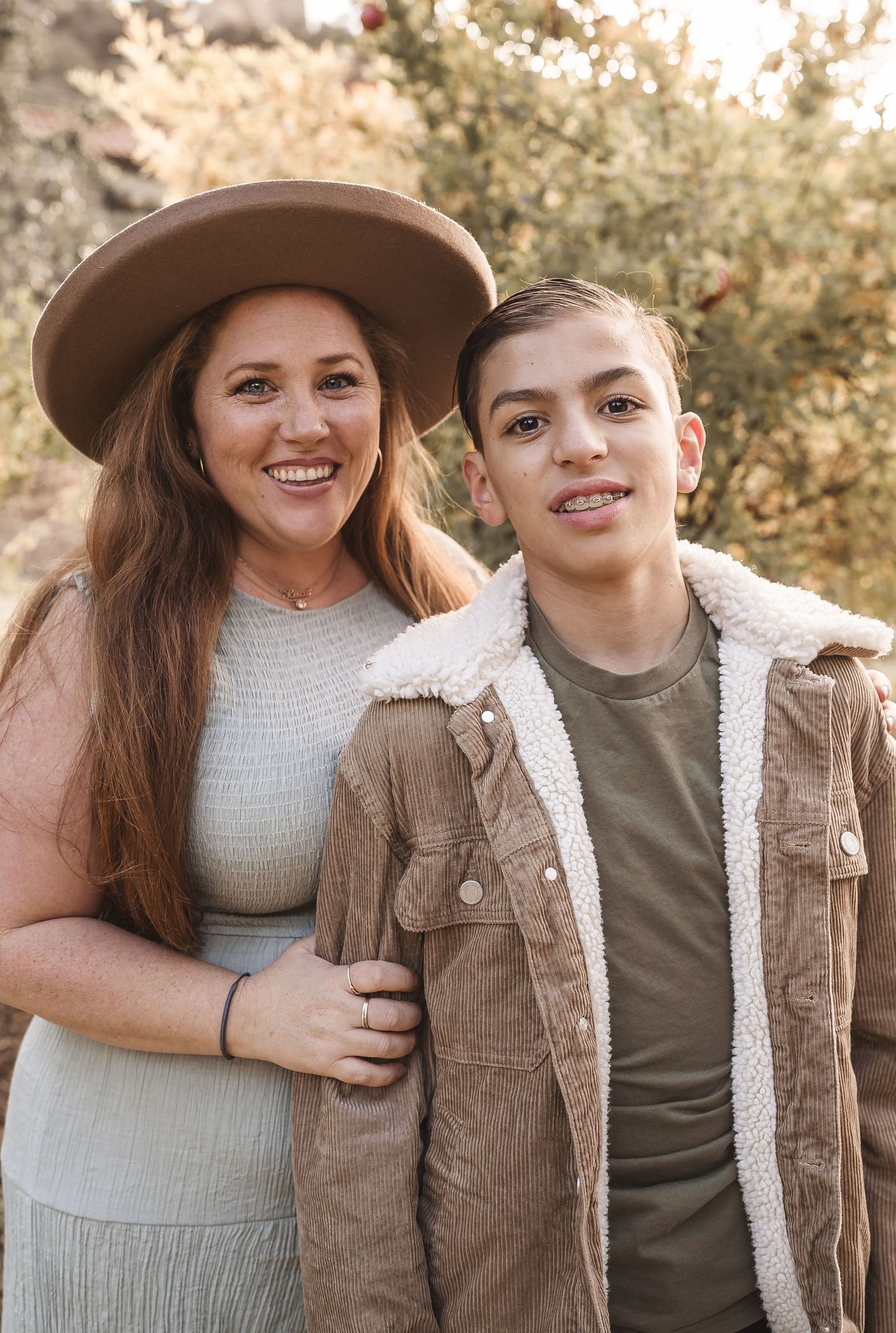 Family portrait series with casual clothing against autumn foliage background.