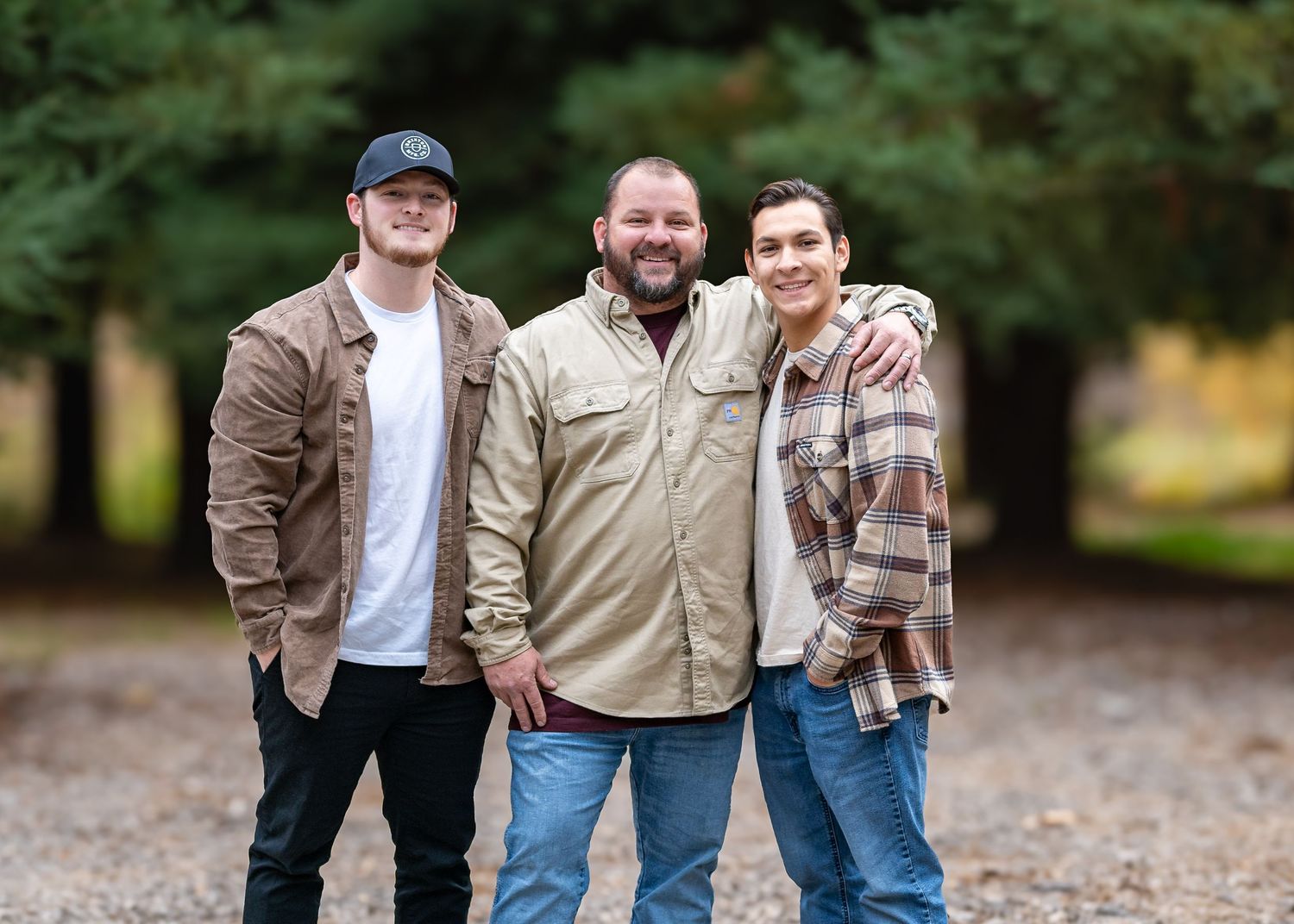 Small group poses casually together outdoors wearing casual autumn attire.