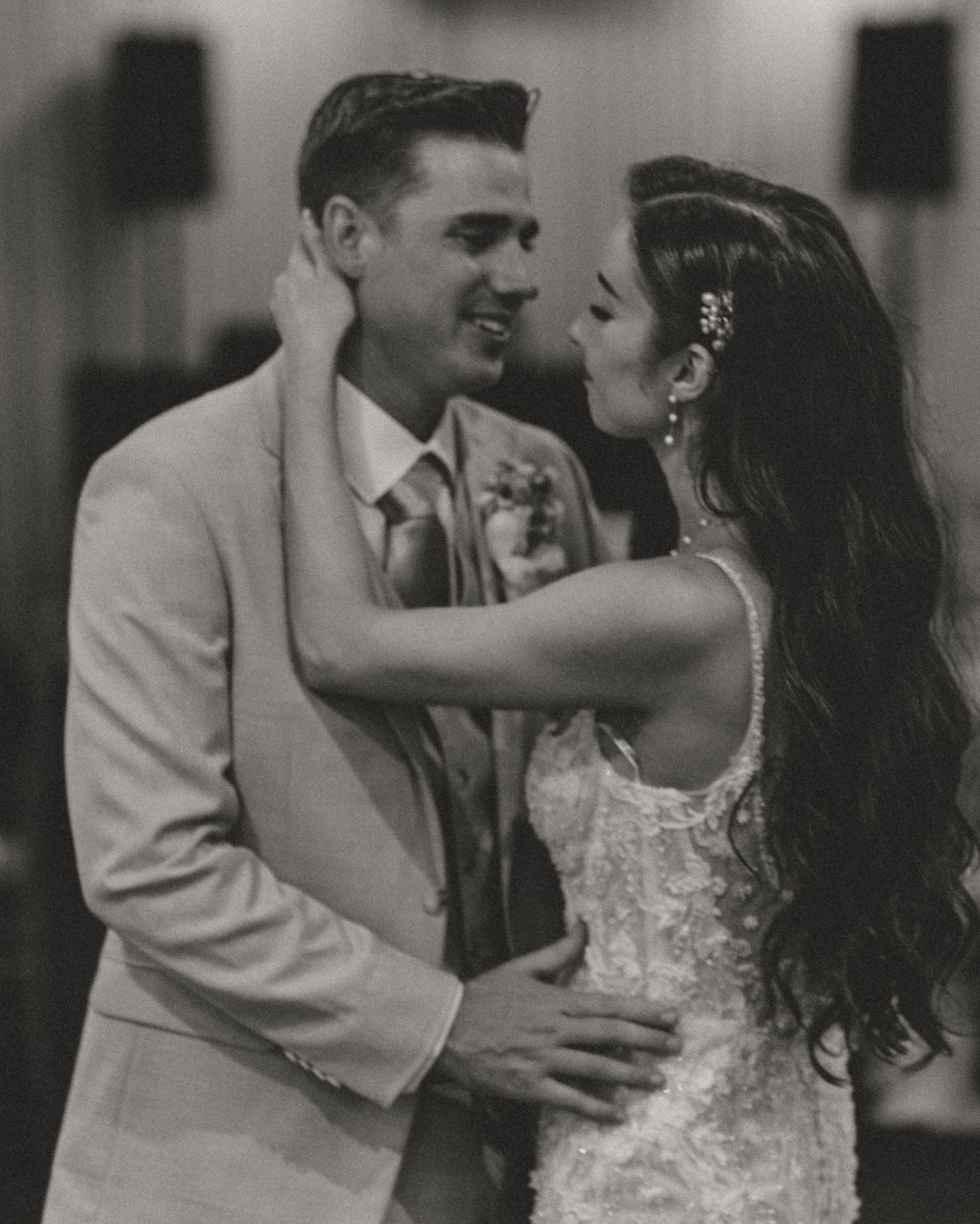 Black and white wedding dance photos showing romantic moments between bride and groom in elegant attire.