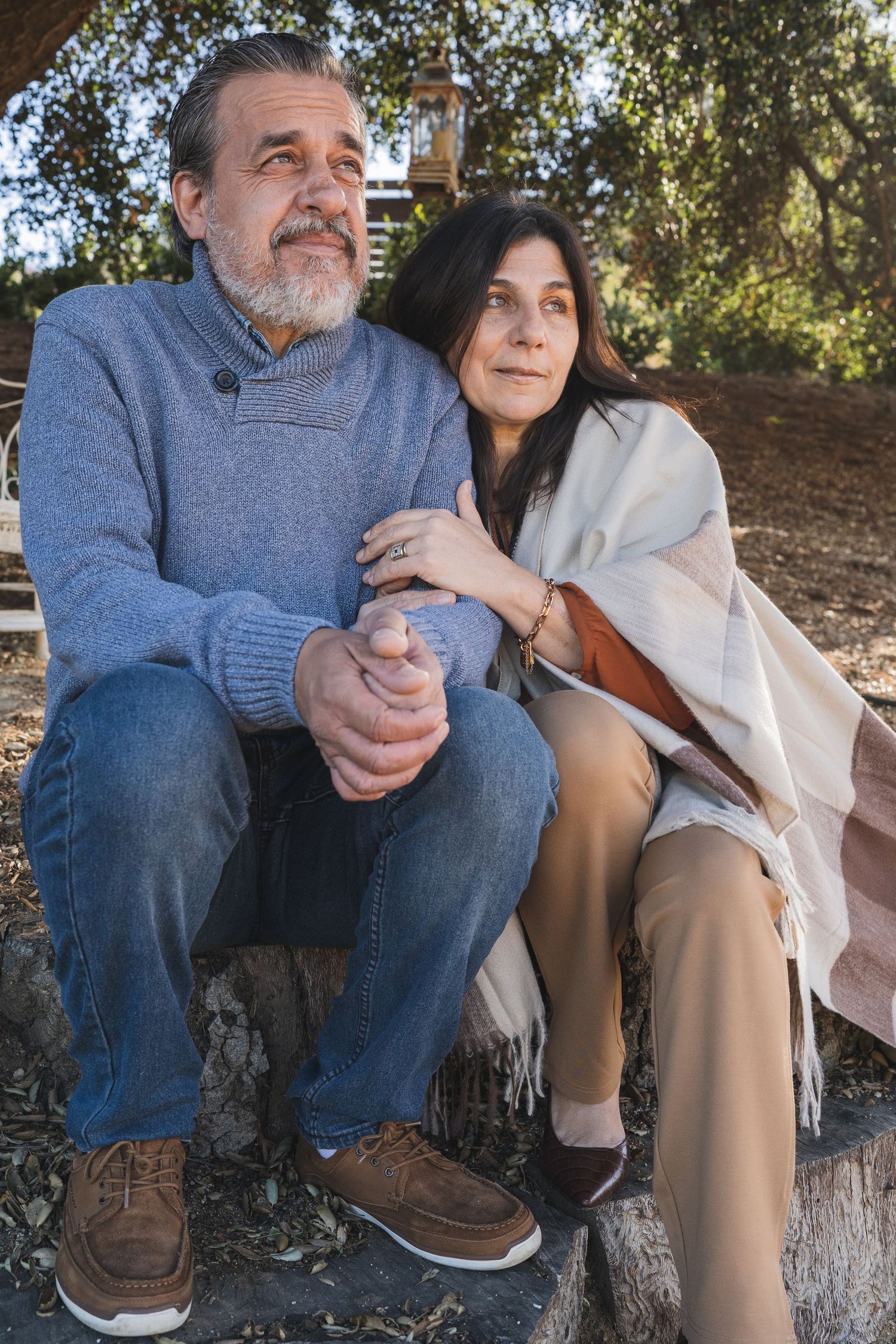 Intimate couple portrait session showing casual clothing and relaxed poses under trees.