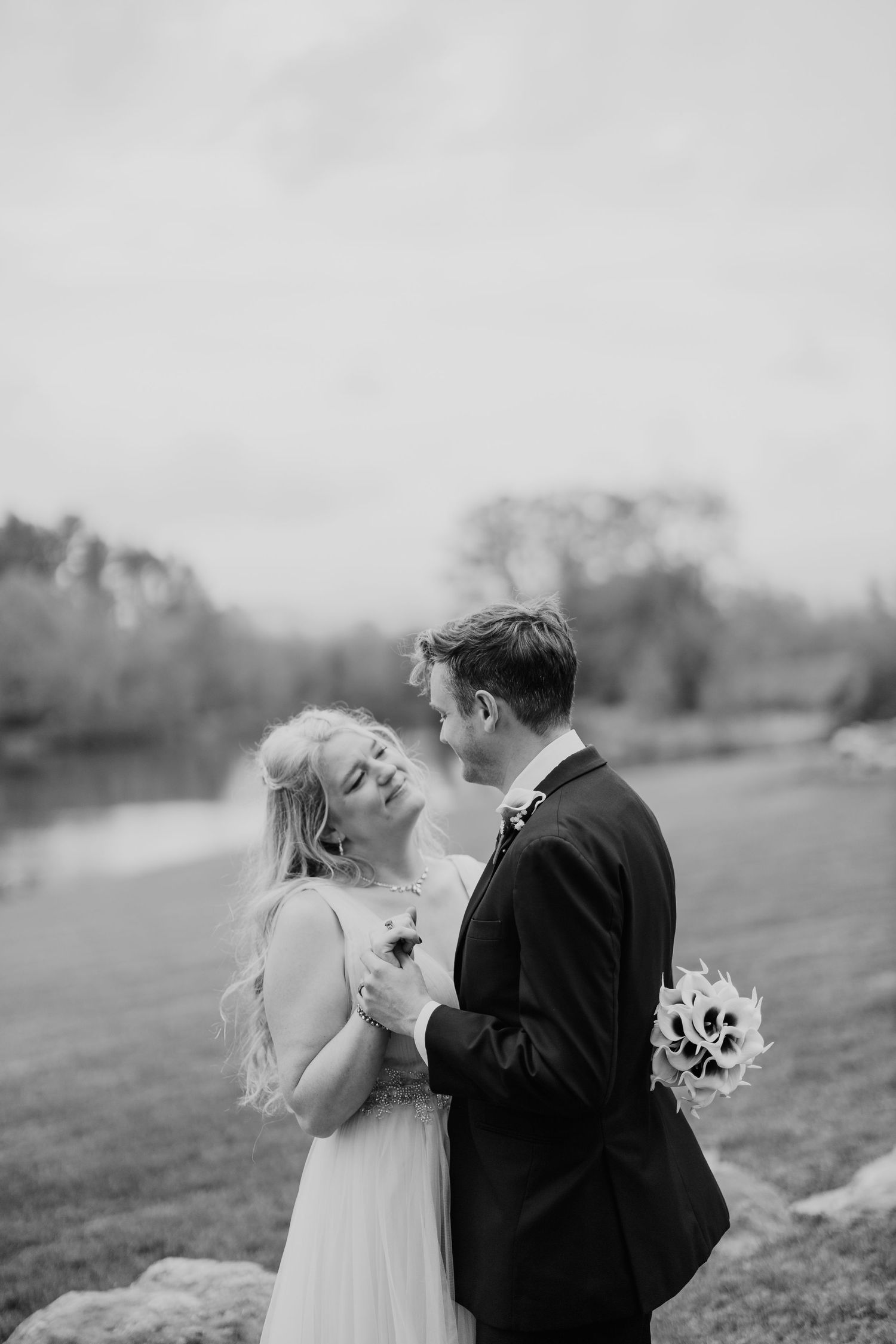 A series of romantic black and white wedding photos showing tender moments between a couple in formal attire.