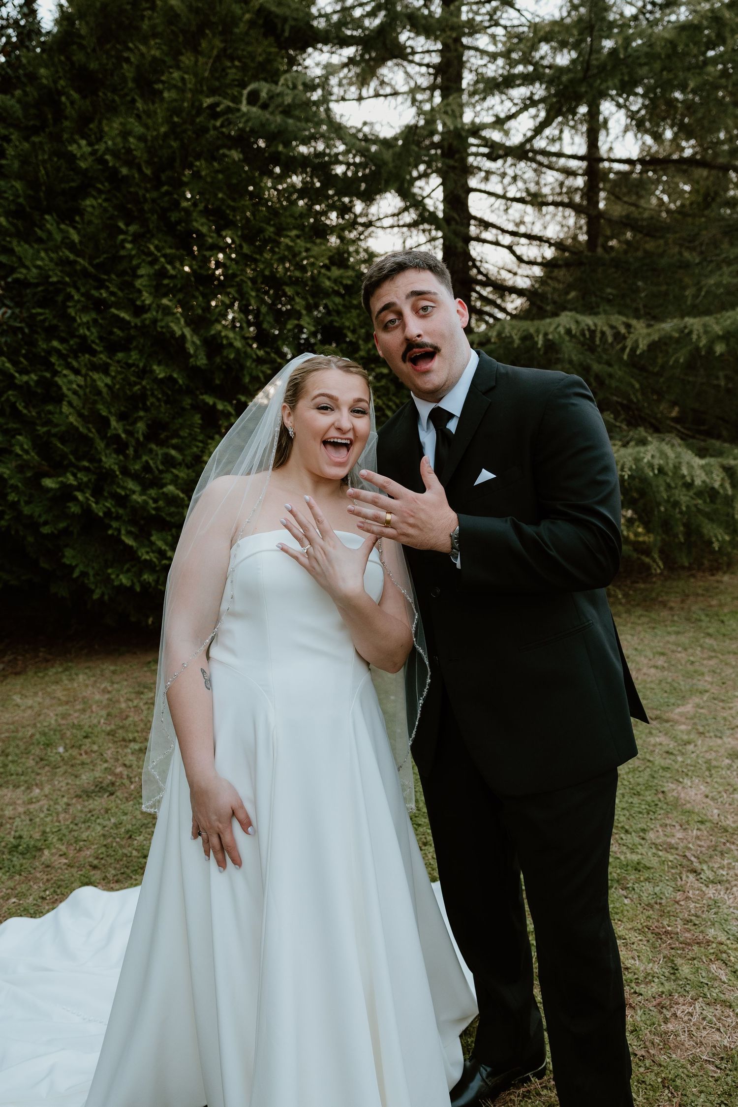 Joyful couple shares candid laughing moments during their wedding photoshoot.