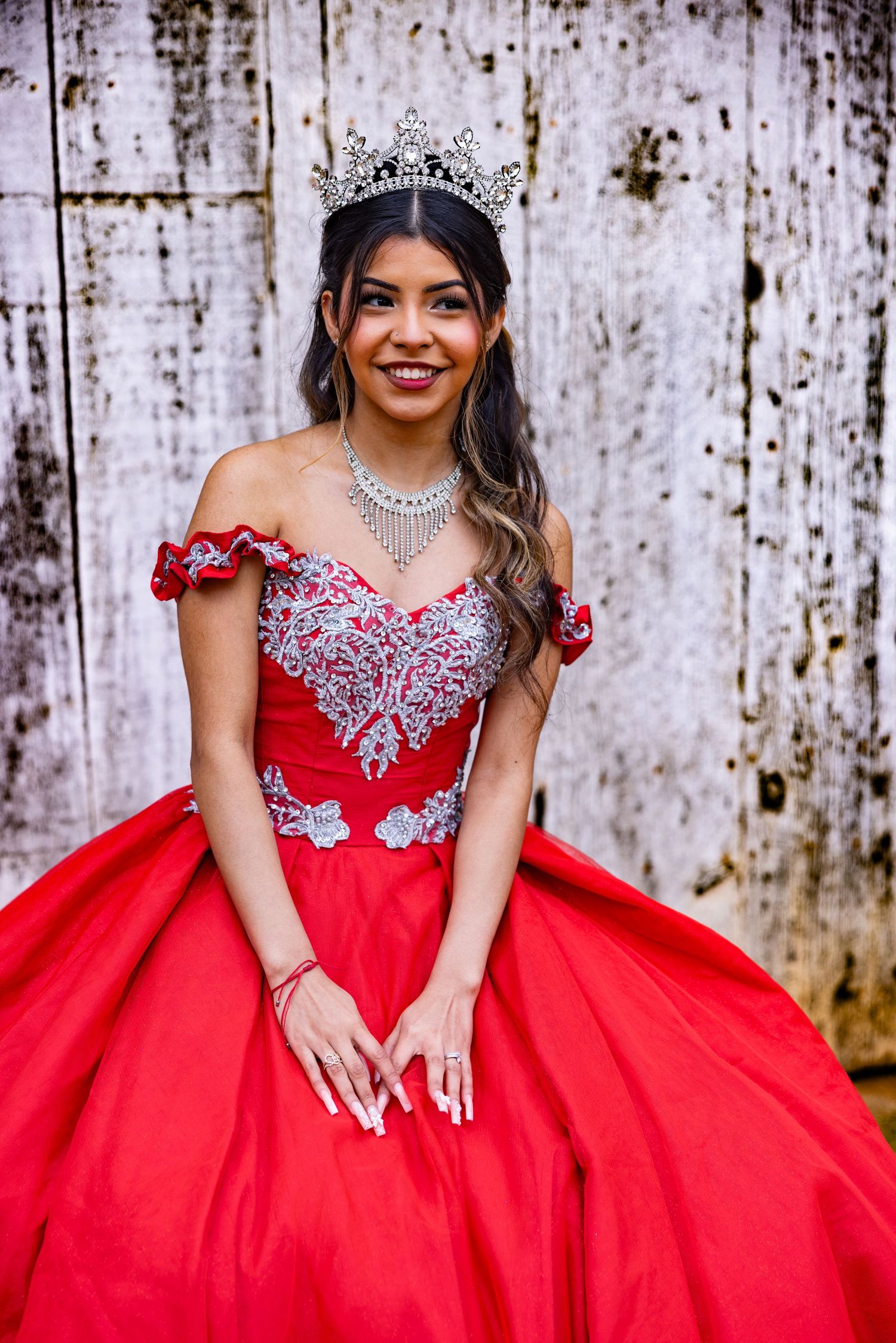 Lodi quinceañera in a red gown and crown, captured by Katie Malinda. Elegant, regal, and timeless portrait in a lush outdoor setting.
