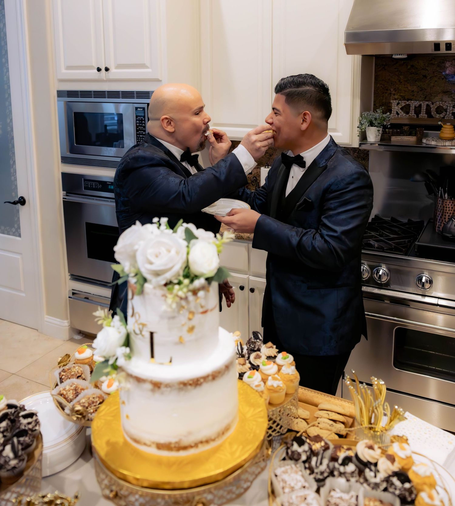 Grooms share a sweet moment during their cake-cutting celebration — candid, joyful wedding photography by Lodi wedding photographer.