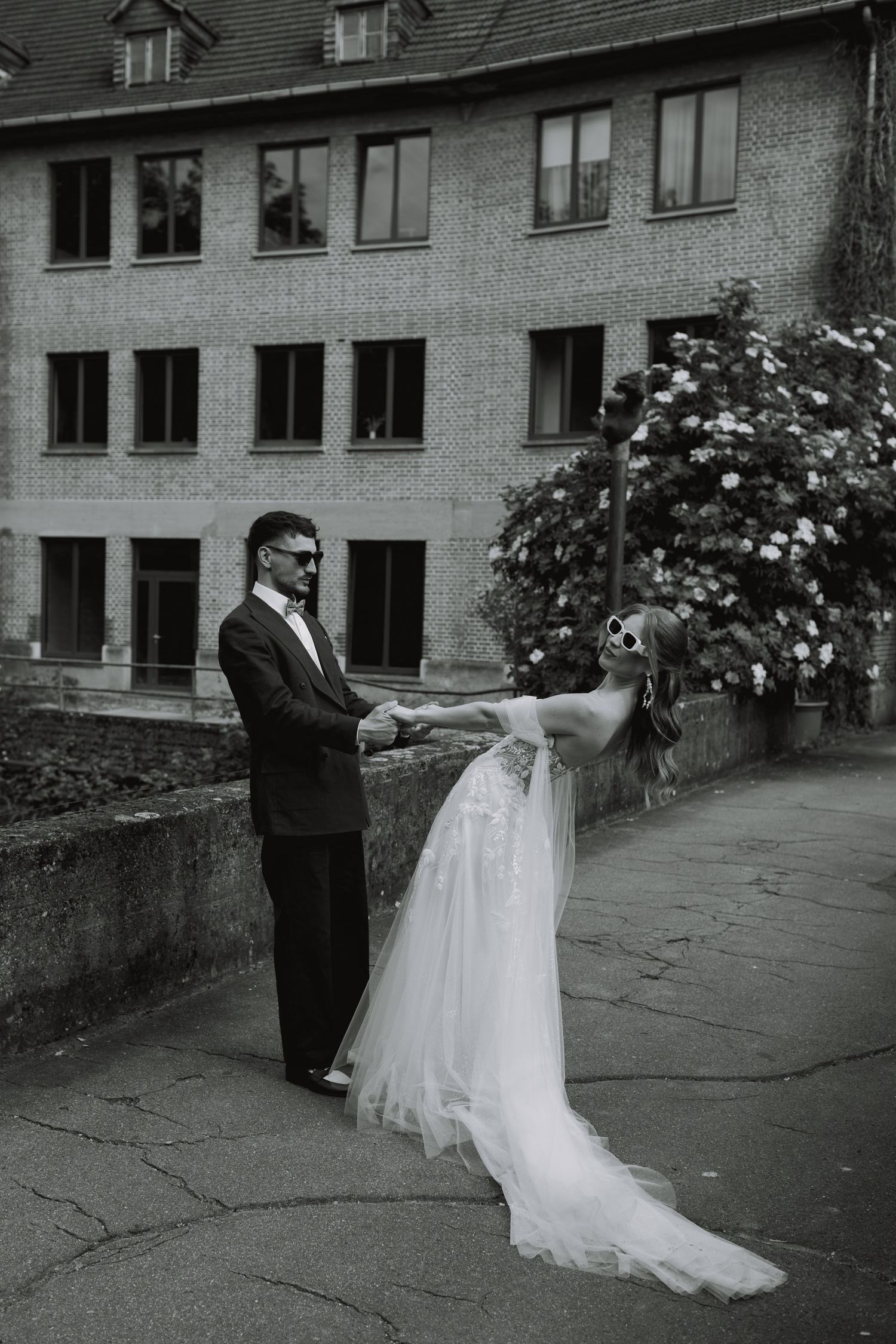 Black and white photo series of a couple dancing outside a brick building.