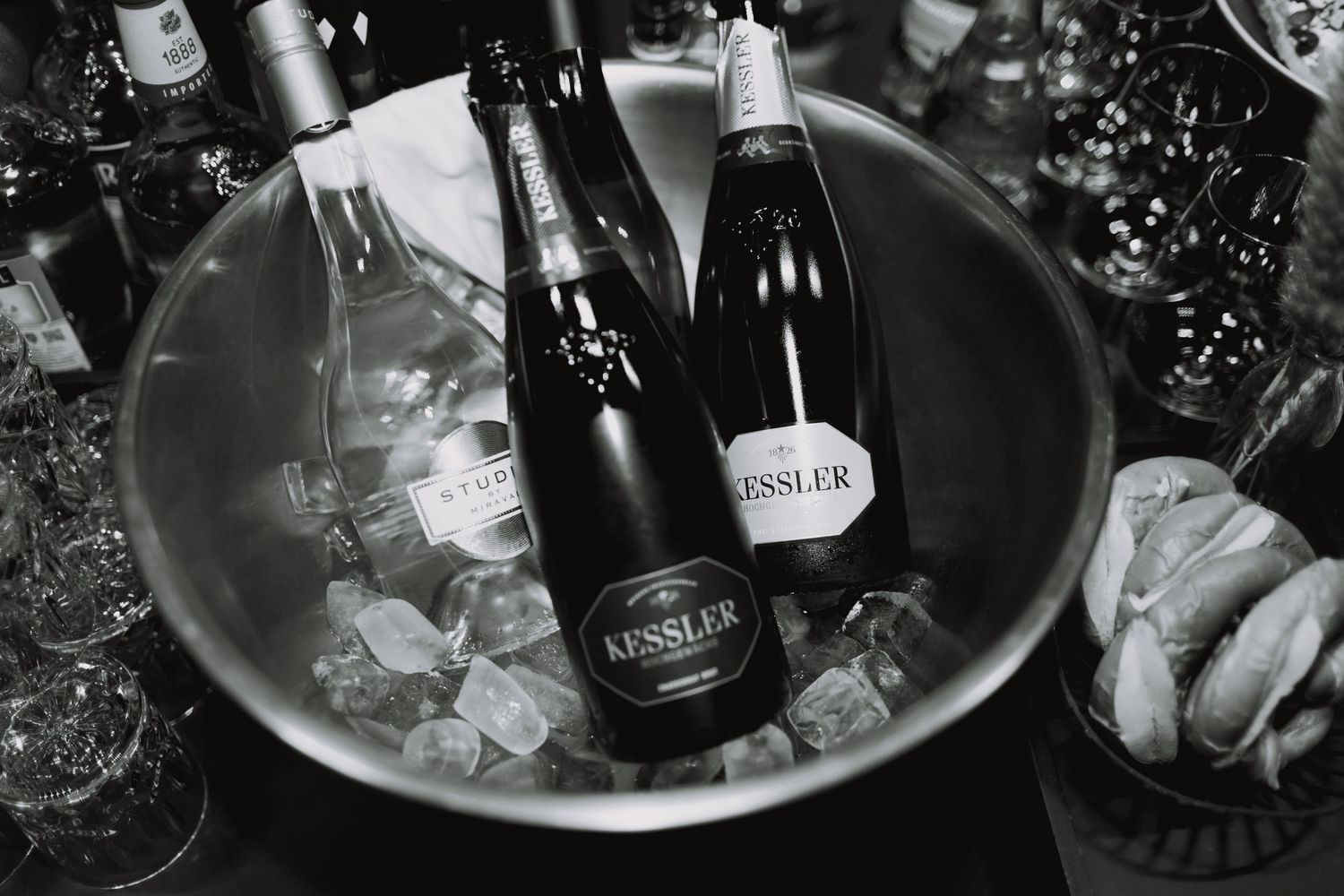 Champagne bottles chilling in ice buckets at an event.