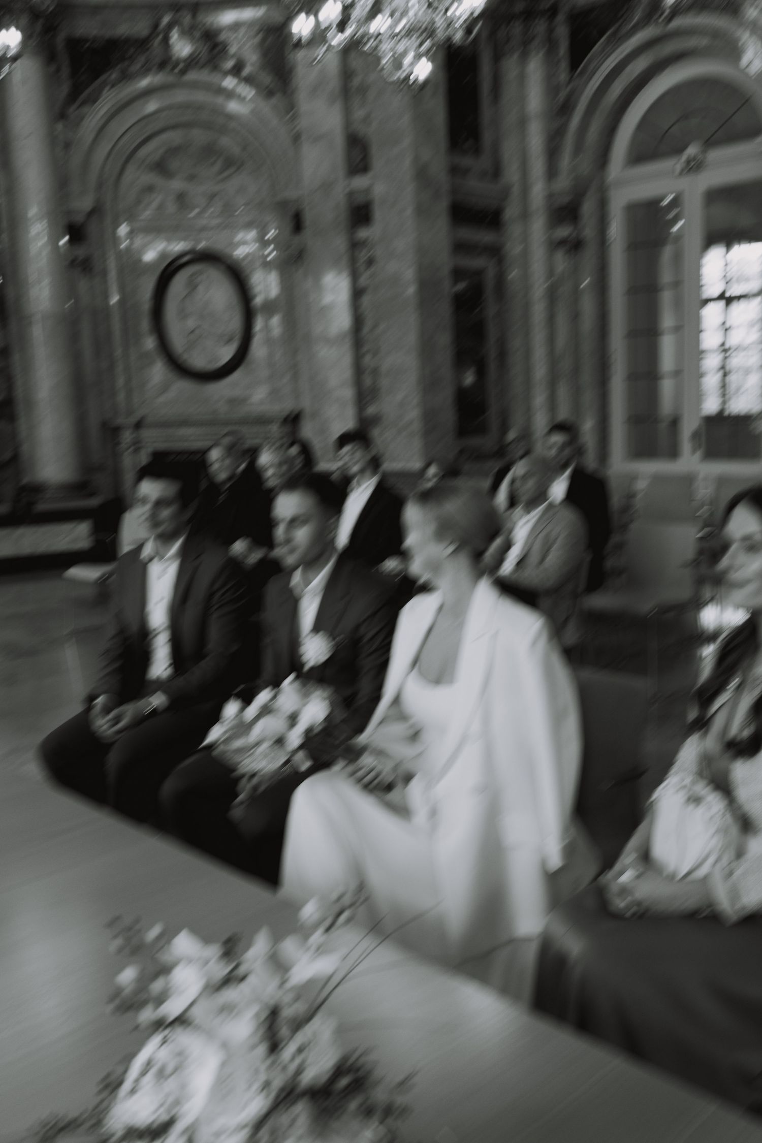 Wedding ceremony in progress inside a grand historic building with ornate architecture.