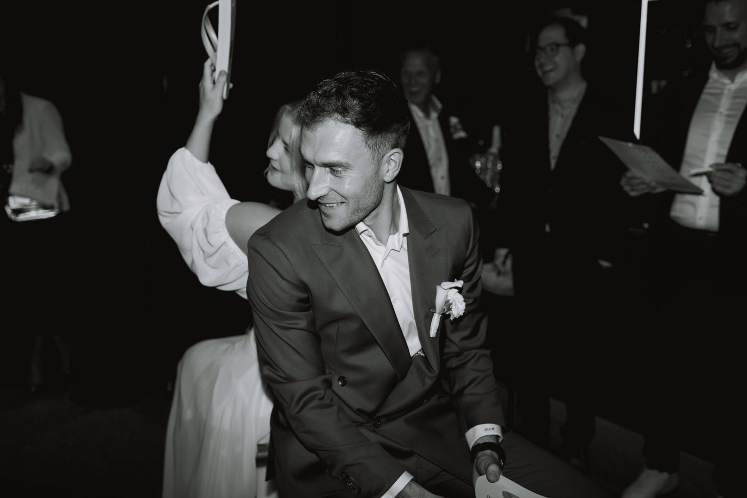 People dancing and celebrating at an elegant evening event.