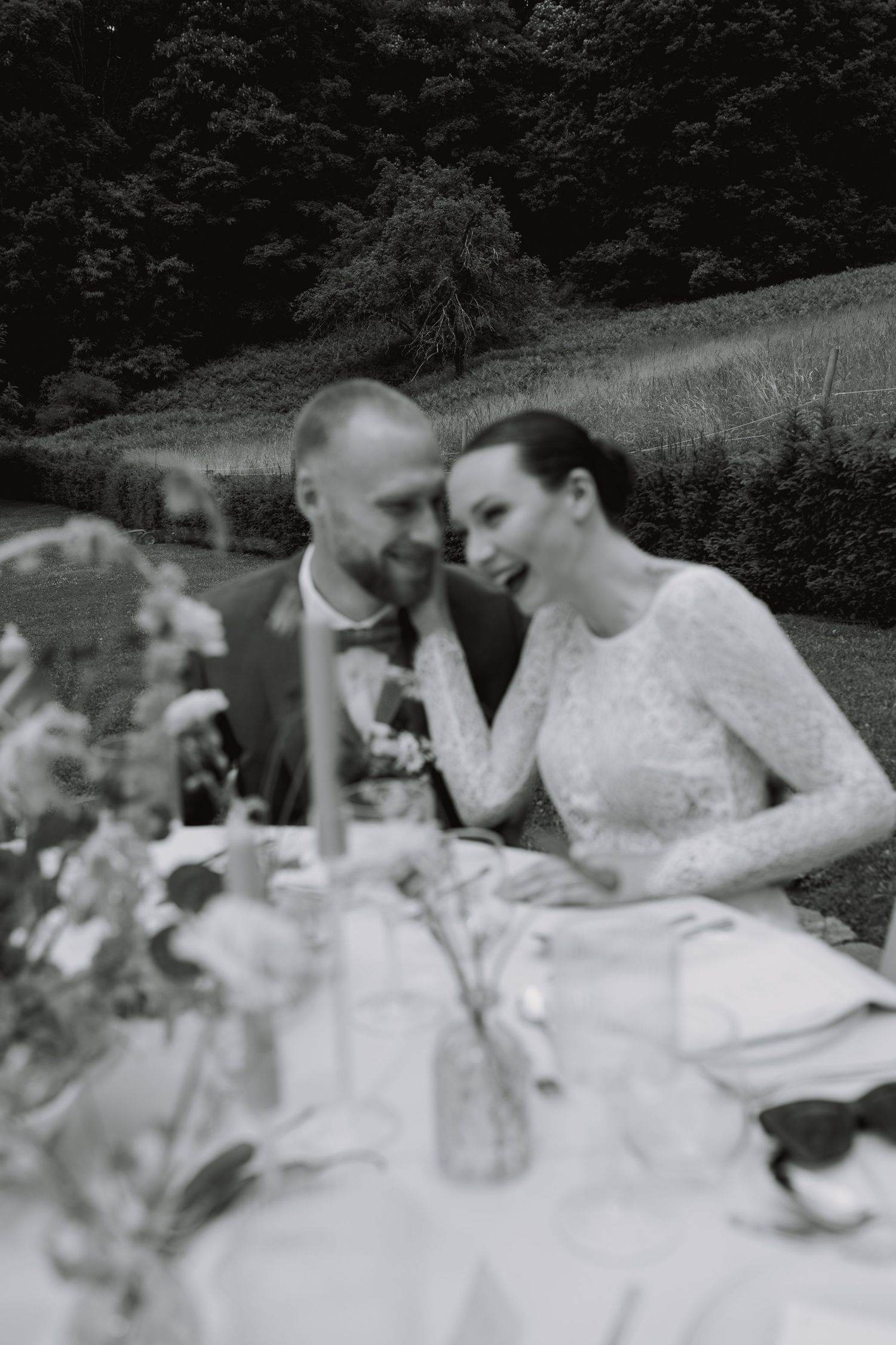 A black and white photo series shows people sitting together at an outdoor table in vintage attire.