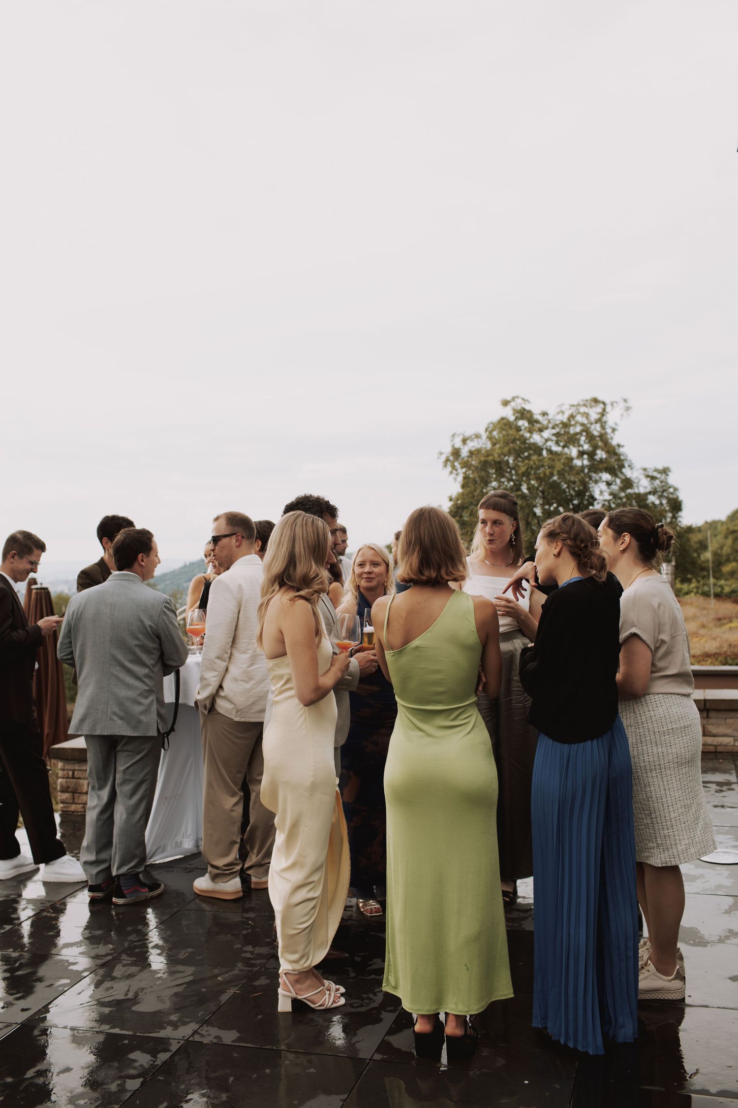 Wedding guests gathered on outdoor terrace for celebration.