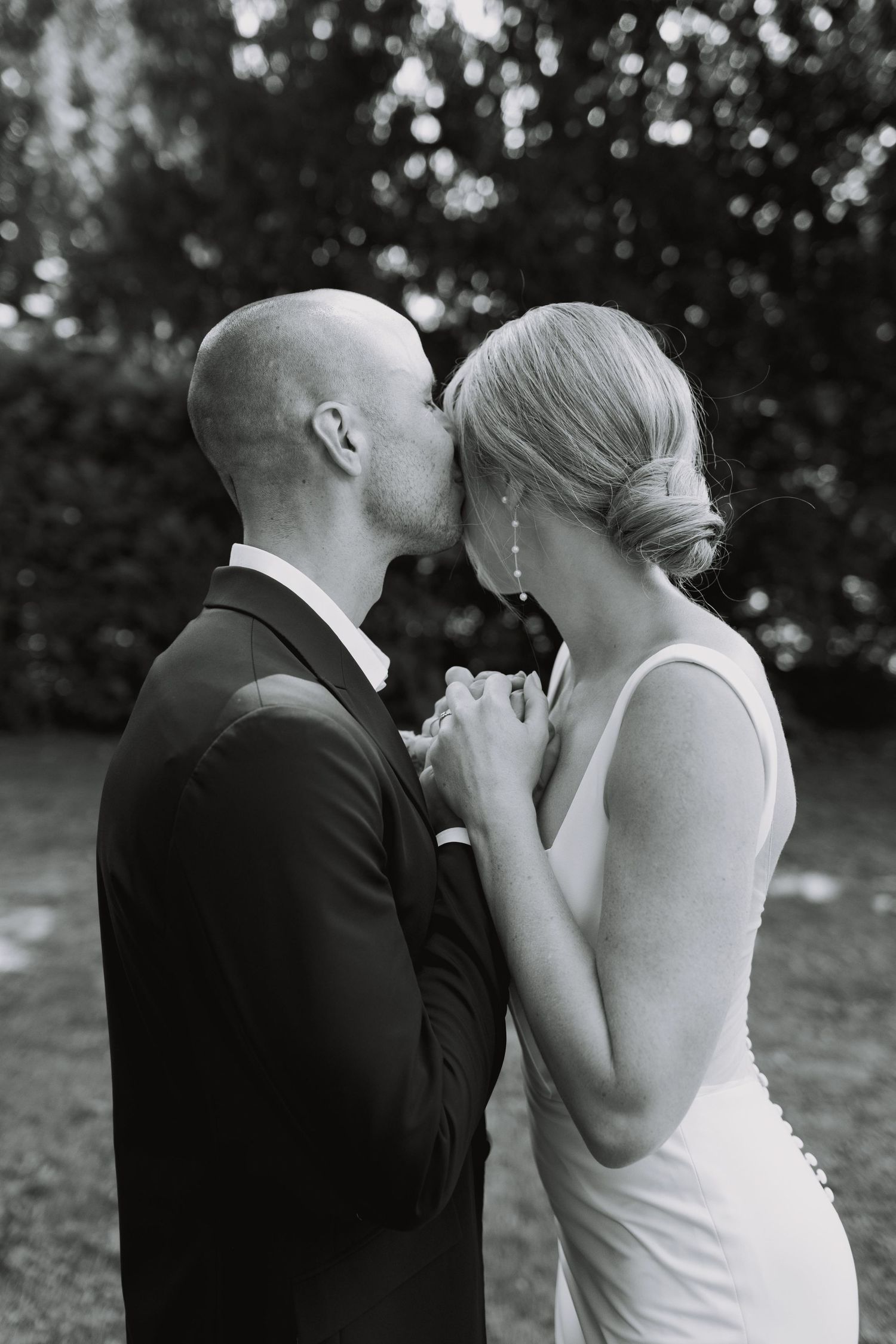 Intimate wedding photography sequence showing tender moments between newlyweds in an outdoor setting.
